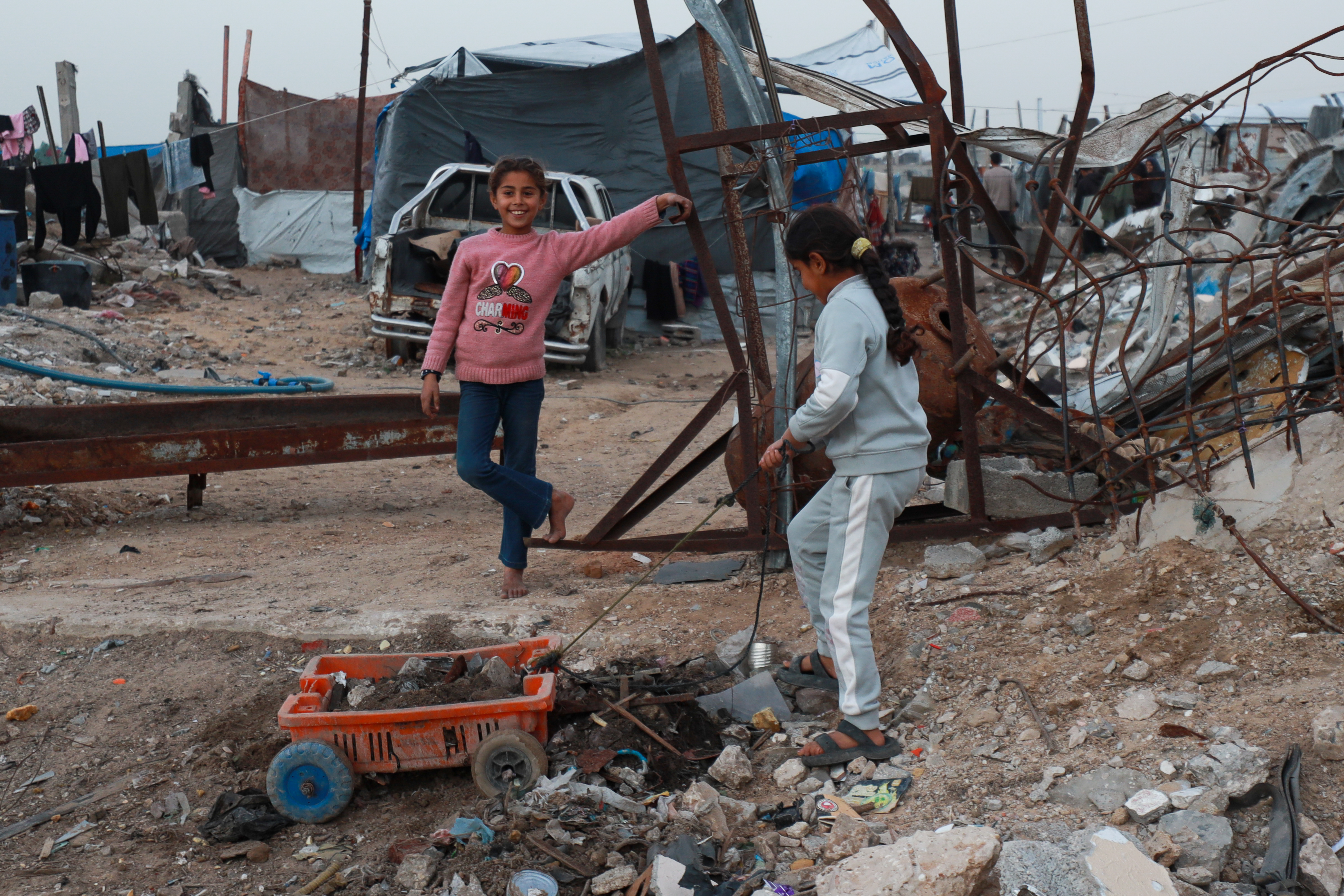 Children play beside the rubble and destroyed buildings in the Deir al-Balah area of central Gaza on February 20, 2026 [Abdelhakim Abu Riash/ Al Jazeera]