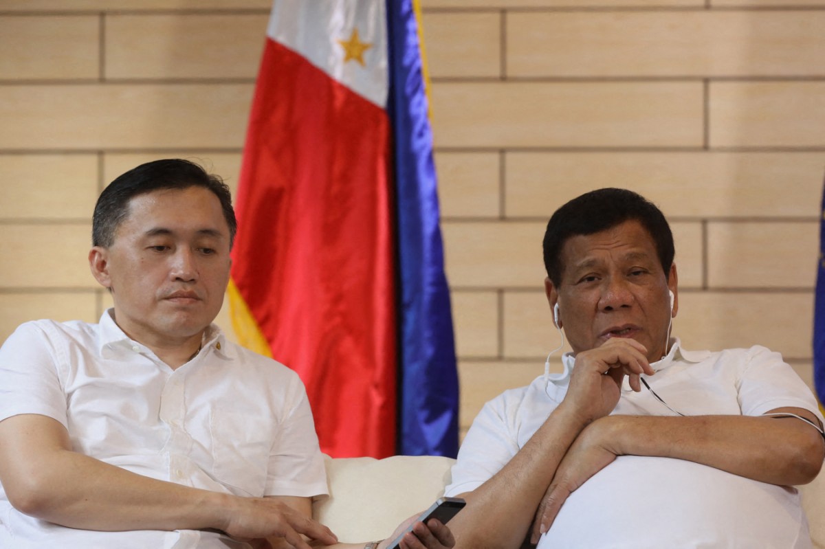 This handout photo taken and released by the Presidential Photographers Division (PPD) on May 3, 2017 shows President Rodrigo Duterte (R, wearing earphones) talking on the phone with Chinese President Xi Jinping while presidential special assistant Bong Go listens in Davao City, southern island of Mindanao. China's President Xi Jinping on May 3 hailed the "dialogue" between Beijing and Manila over their border dispute in the South China Sea during a phone call with Philippine leader Rodrigo Duterte, state media reported. (Photo by Handout / PPD / AFP) / RESTRICTED TO EDITORIAL USE - MANDATORY CREDIT "AFP PHOTO / PRESIDENTIAL PHOTOGRAPHERS DIVISION" - NO MARKETING NO ADVERTISING CAMPAIGNS - DISTRIBUTED AS A SERVICE TO CLIENTS
