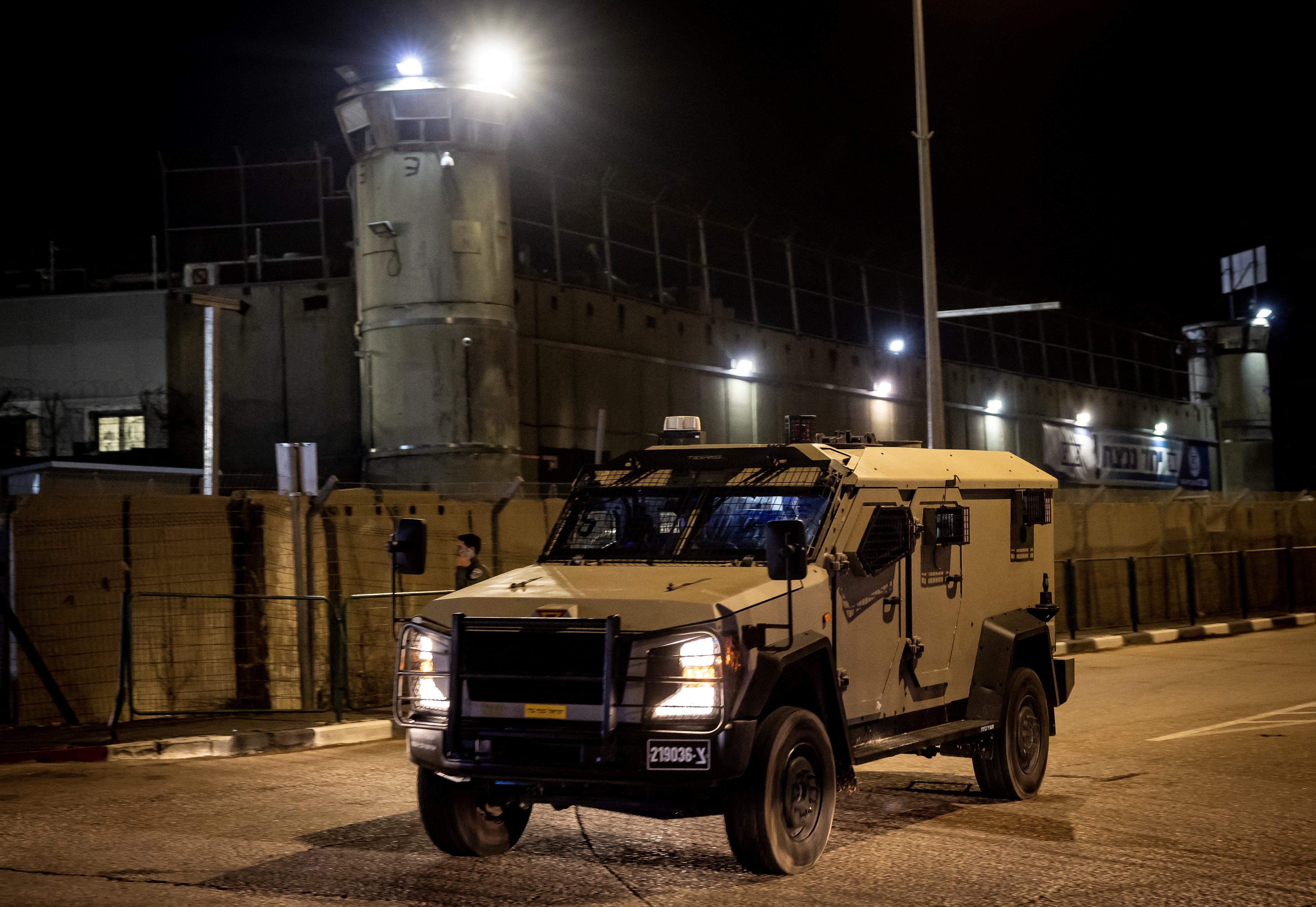 An Israeli army vehicle drives outside the Ofer military prison located between Ramallah and Beitunia in the occupied West Bank on November 30, 2023, before the release of Palestinian prisoners in exchange for hostages held by Hamas in Gaza since the October 7 attacks. (Photo by FADEL SENNA / AFP)