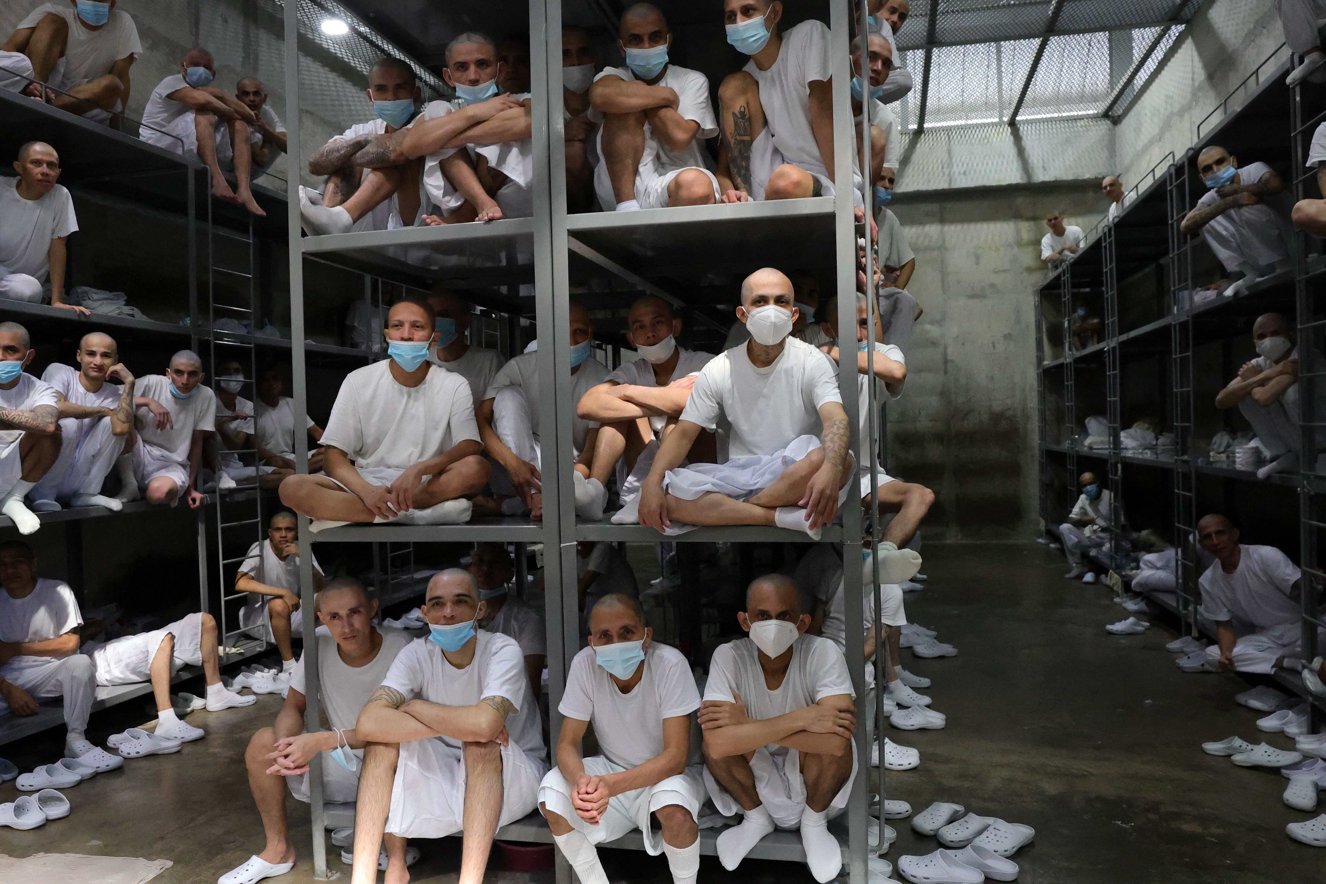 Inmates remain in a cell during a visit by Chiles president-elect Jose Antonio Kast (out of frame) to the Counter-Terrorism Confinement Centre (CECOT) mega-prison, where hundreds of MS-13 and 18th Street gang members are being held, in Tecoluca, El Salvador