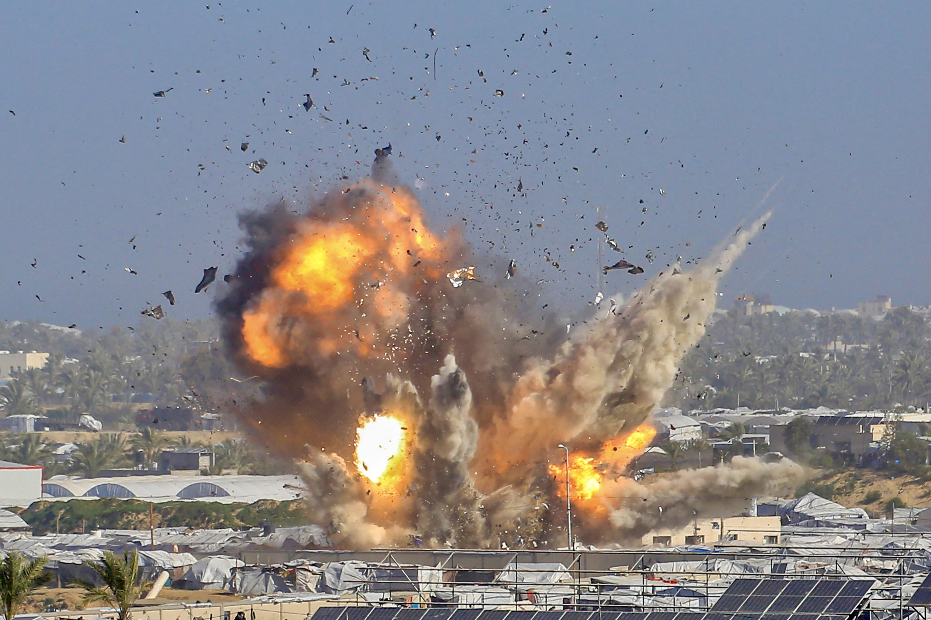 Smoke and fire rises from the Gath shelter, housing displaced Palestinians, after an Israeli air strike in the west of Khan Younis, southern Gaza Strip