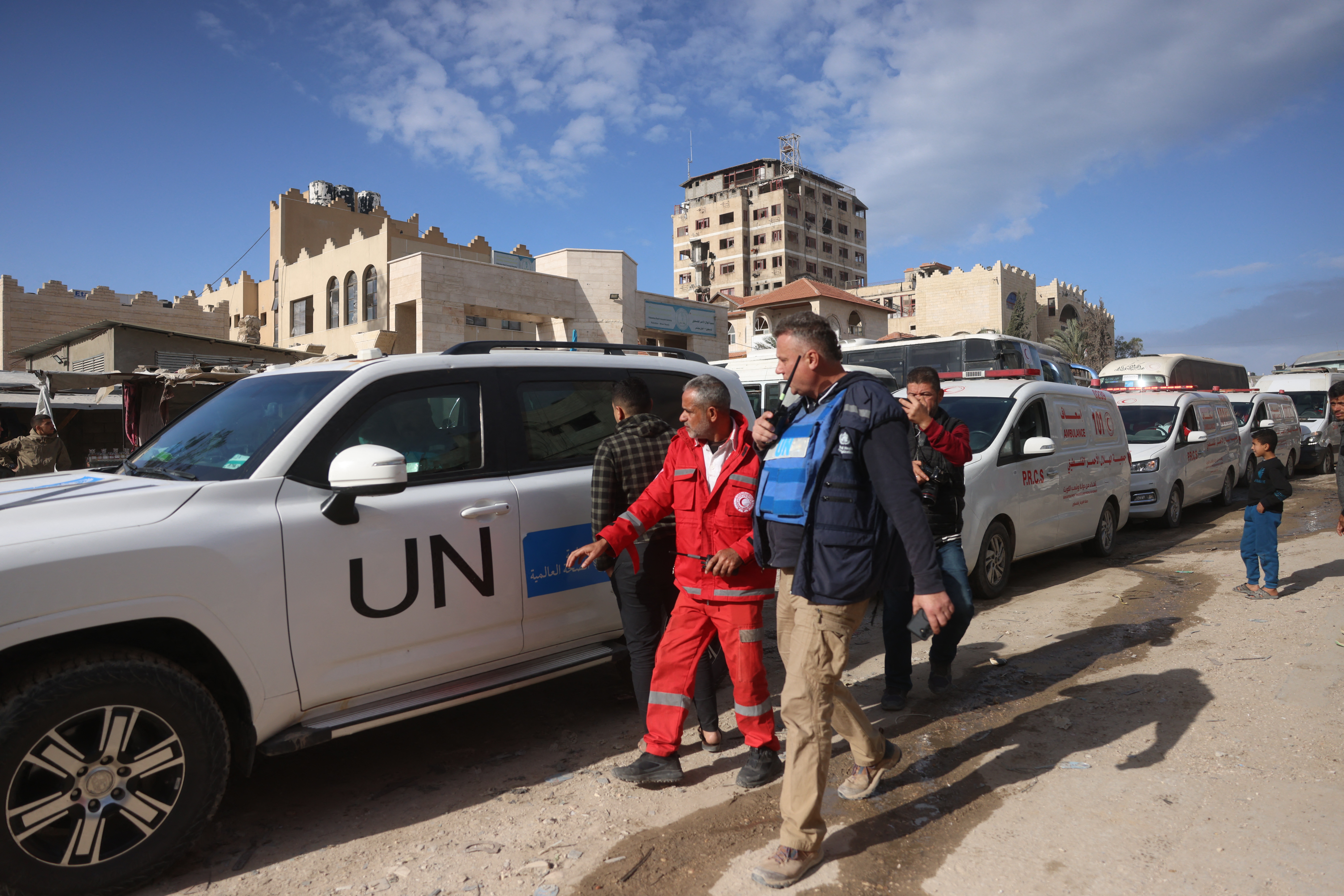 World Health Organisation officials help with the evacuation of Palestinian patients and war-wounded people to leave the Gaza Strip for treatment abroad through the Rafah border crossing between Gaza and Egypt, days after it was opened by Israel for a limited number of people, in Khan Yunis, in the southern Gaza Strip on February 3, 2026. Dozens of injured Palestinians and their companions entered Egypt from Gaza on January 1, the first day of a limited reopening of the Rafah border crossing, a source on the Egyptian side of the border told AFP. The reopening, demanded by the United Nations and aid groups, is a key part of the second phase of US President Donald Trump's truce plan for Gaza, where humanitarian conditions remain dire after two years of war. (Photo by Bashar Taleb / AFP)