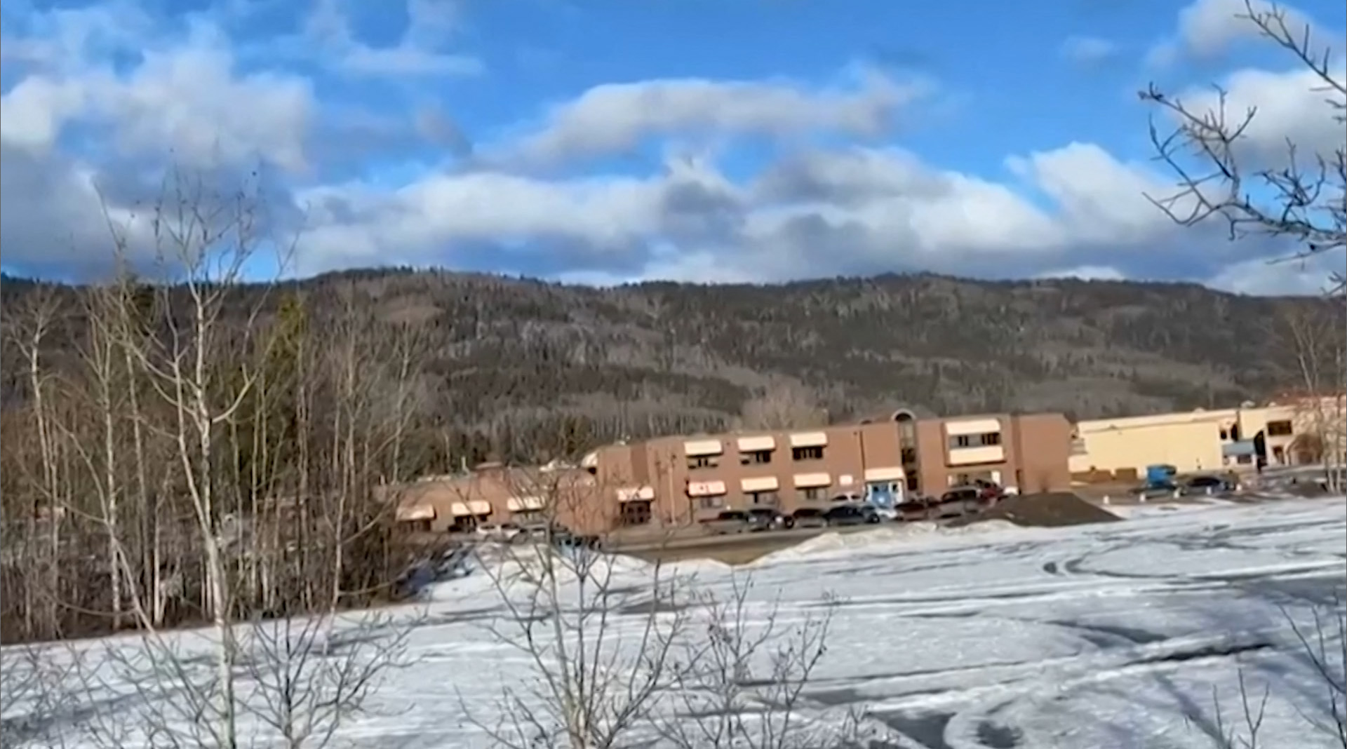 This screengrab of a video provided by local journalist Trent Ernst shows the middle school and high school building where a shooting took place, leaving at least nine people dead in the small town of Tumbler Ridge, British Columbia, on February 10, 2026. (Photo by Trent Ernst / AFP) / XGTY / RESTRICTED TO EDITORIAL USE - MANDATORY CREDIT "AFP PHOTO / TRENT ERNST" - NO MARKETING NO ADVERTISING CAMPAIGNS - DISTRIBUTED AS A SERVICE TO CLIENTS