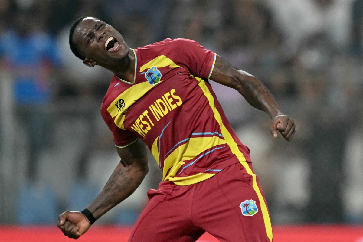 West Indies' Shamar Joseph celebrates after taking the wicket of England's Adil Rashid during the 2026 ICC Men's T20 Cricket World Cup group stage match between England and West Indies at the Wankhede Stadium in Mumbai on February 11, 2026. (Photo by Indranil MUKHERJEE / AFP)
