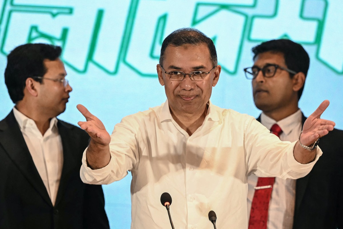 Bangladesh Nationalist Party (BNP) Chairman Tarique Rahman (C) gestures as he arrives to address a news conference.