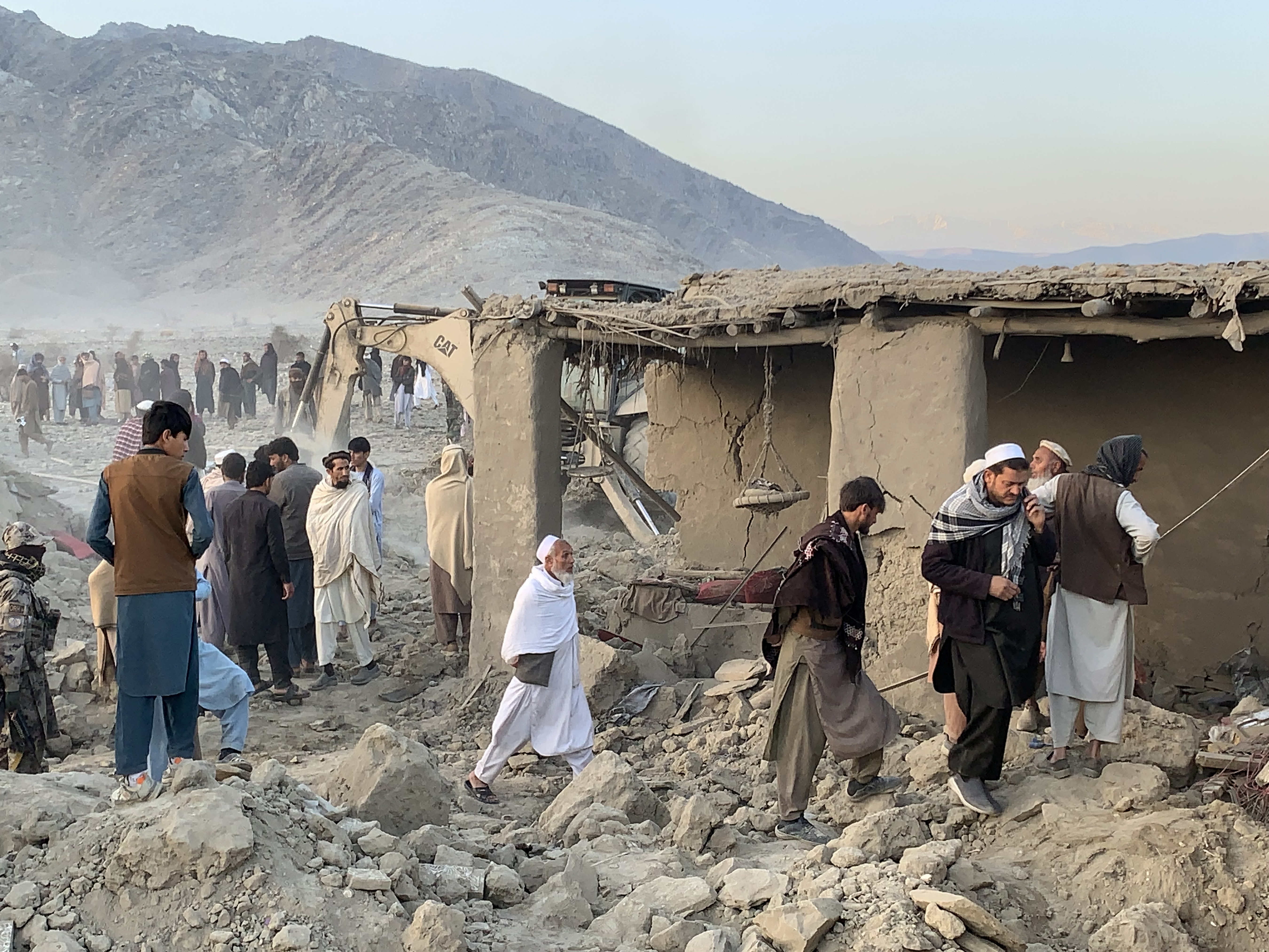 fghan men search for victims after an overnight Pakistani airstrike hit a residential area in the Girdi Kas village of Bihsud district,