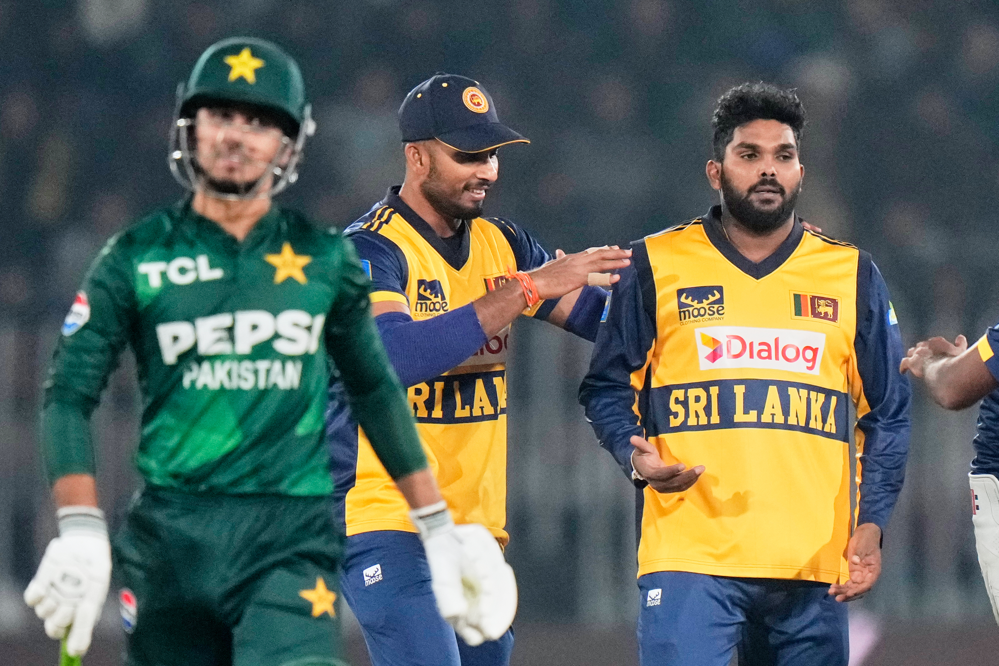 Sri Lanka's Wanindu Hasaranga, right, celebrates with teammate after the dismissal of Pakistan's Saim Ayub, left, during the final of tri-series T20 cricket match between Pakistan and Sri Lanka, in Rawalpindi, Pakistan, Saturday, Nov. 29, 2025
