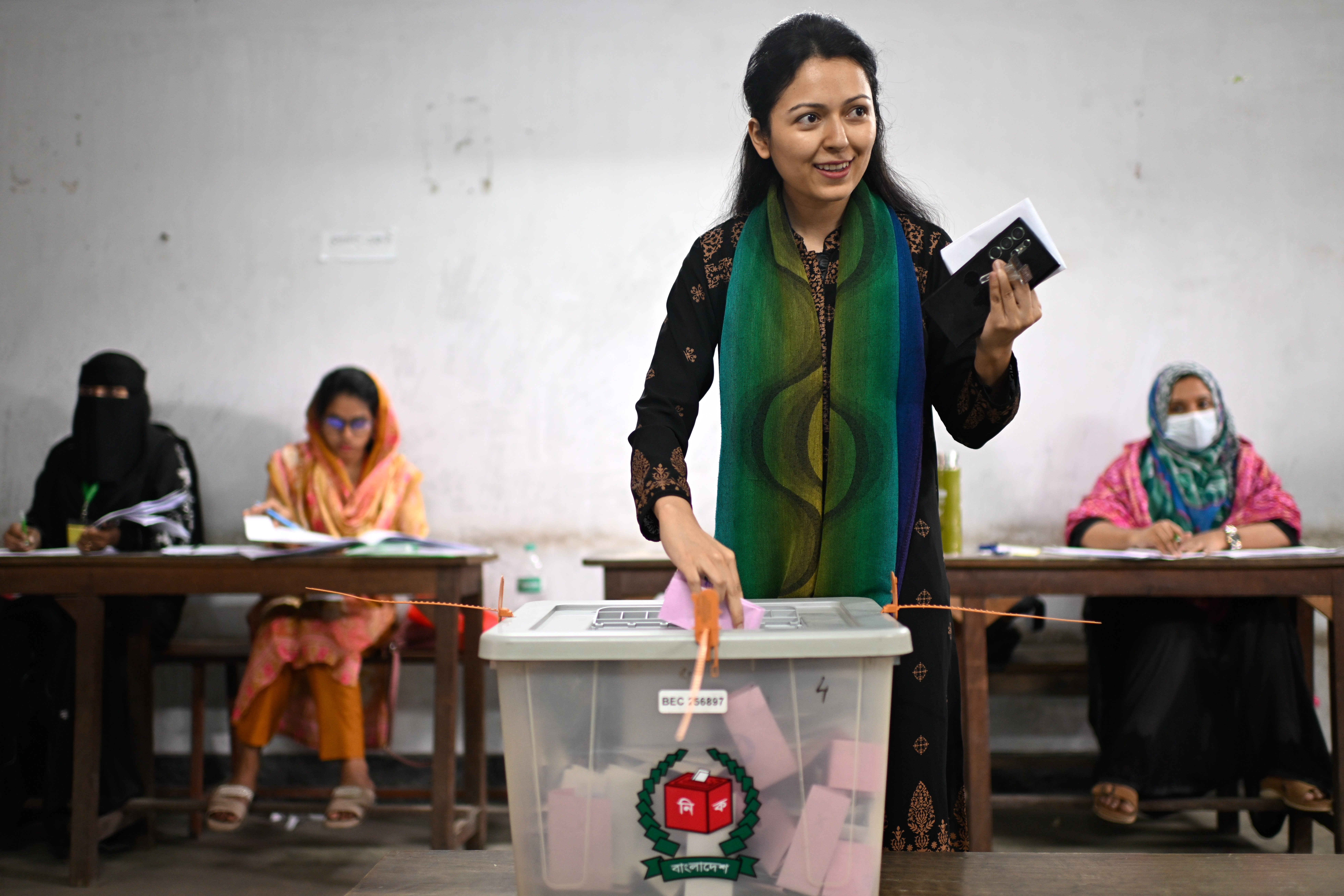 A woman casts her vote at a polling station during Bangladesh's national parliamentary election, in Dhaka