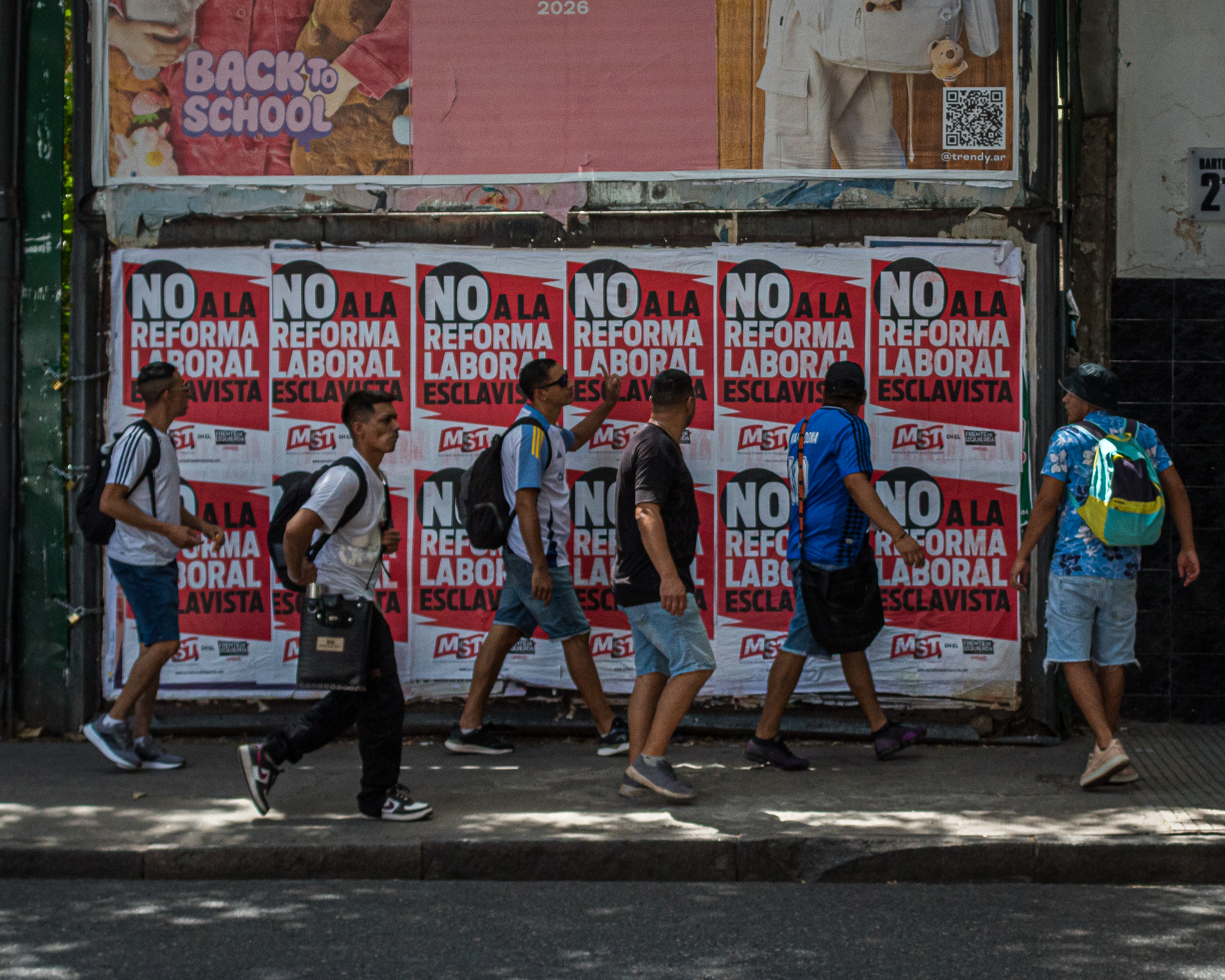 Young people march against the labour reform bill, passing posters denouncing the legislation