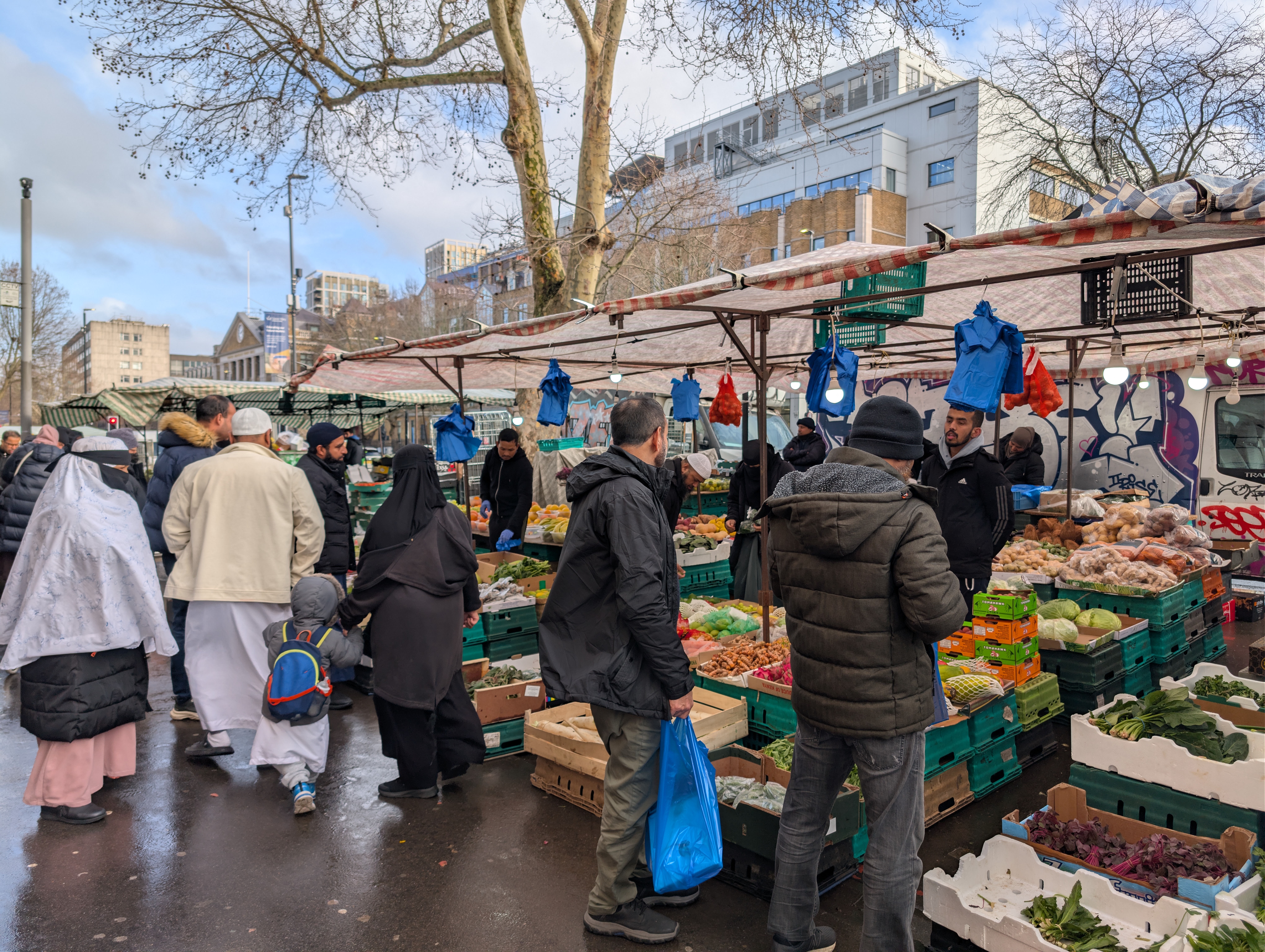People buying fruits and vegetables at Whitechapel market. The neighbourhood has a significant Bangladeshi origin population — and excitement over the February 12 election in their home country is palpable [