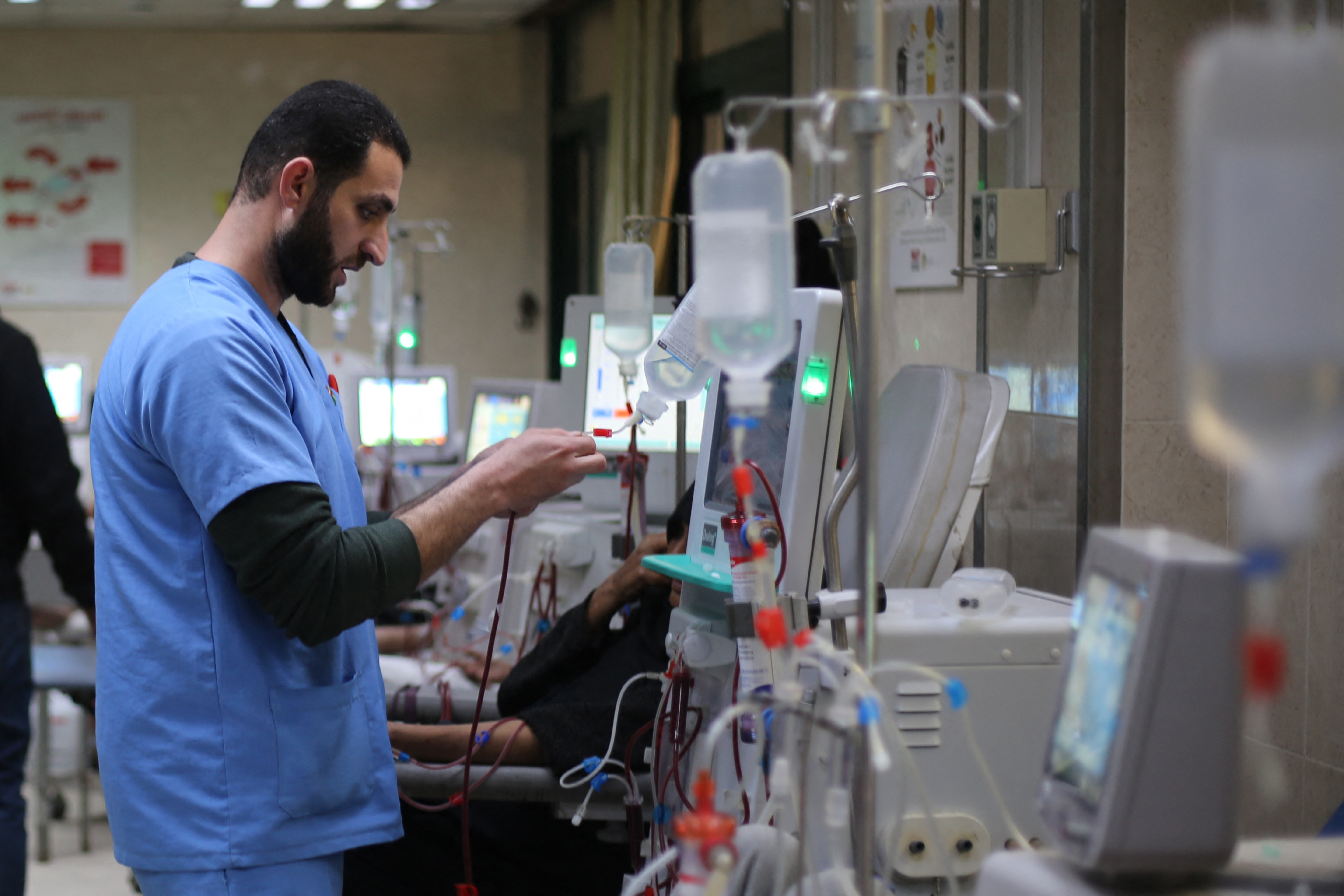 A Palestinian doctor checks a drip at the dialysis treatment centre at Al-Aqsa Martyrs Hospital, Deir el-Balah, in the central Gaza Strip, on February 1, 2026 [AFP]