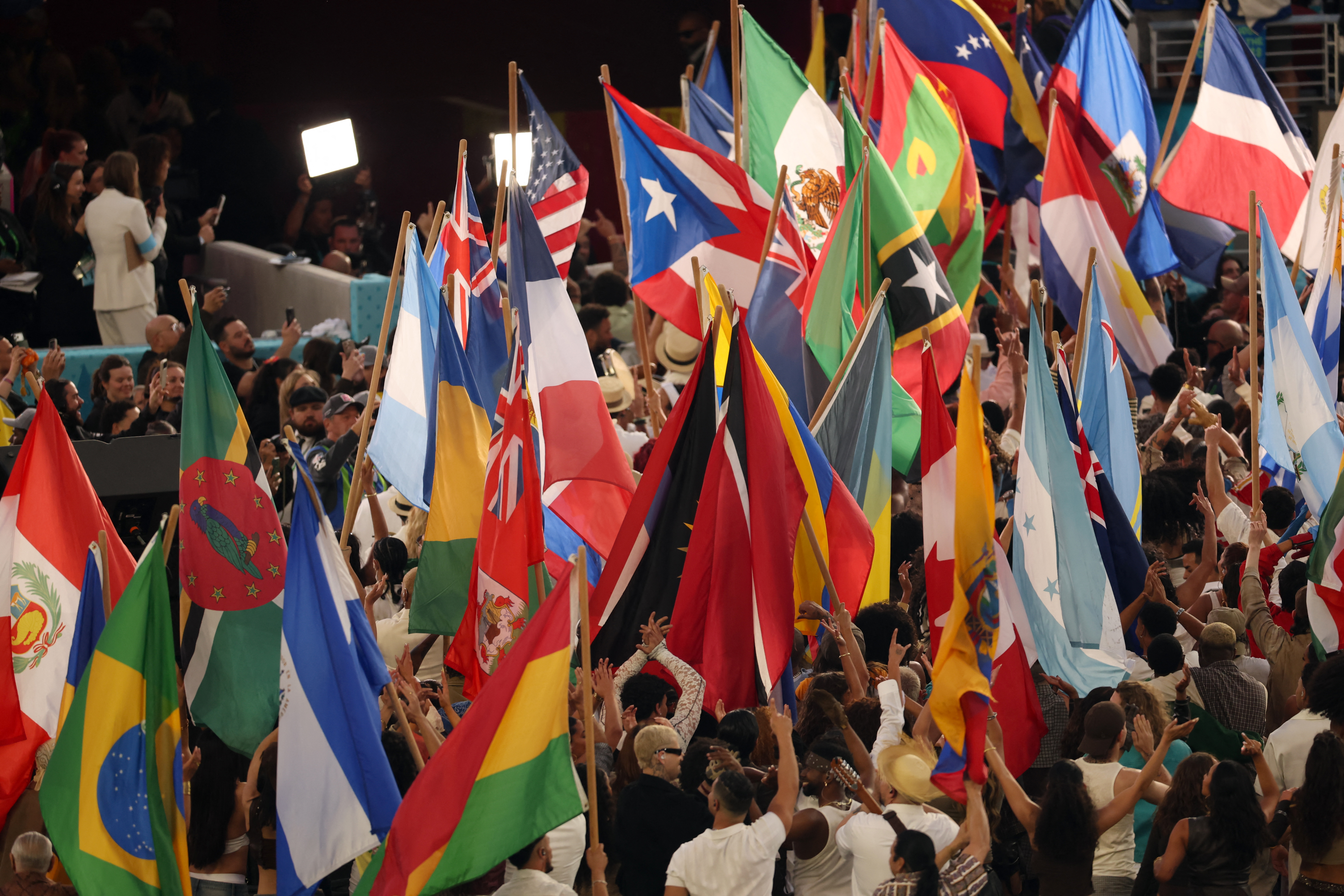 Performers wave the flags of sovereign countries in the Americas at the conclusion of Puerto Rican singer Bad Bunny performance during Super Bowl LX Patriots vs Seahawks Apple Music Halftime Show at Levi's Stadium in Santa Clara, California on February 8, 2026.