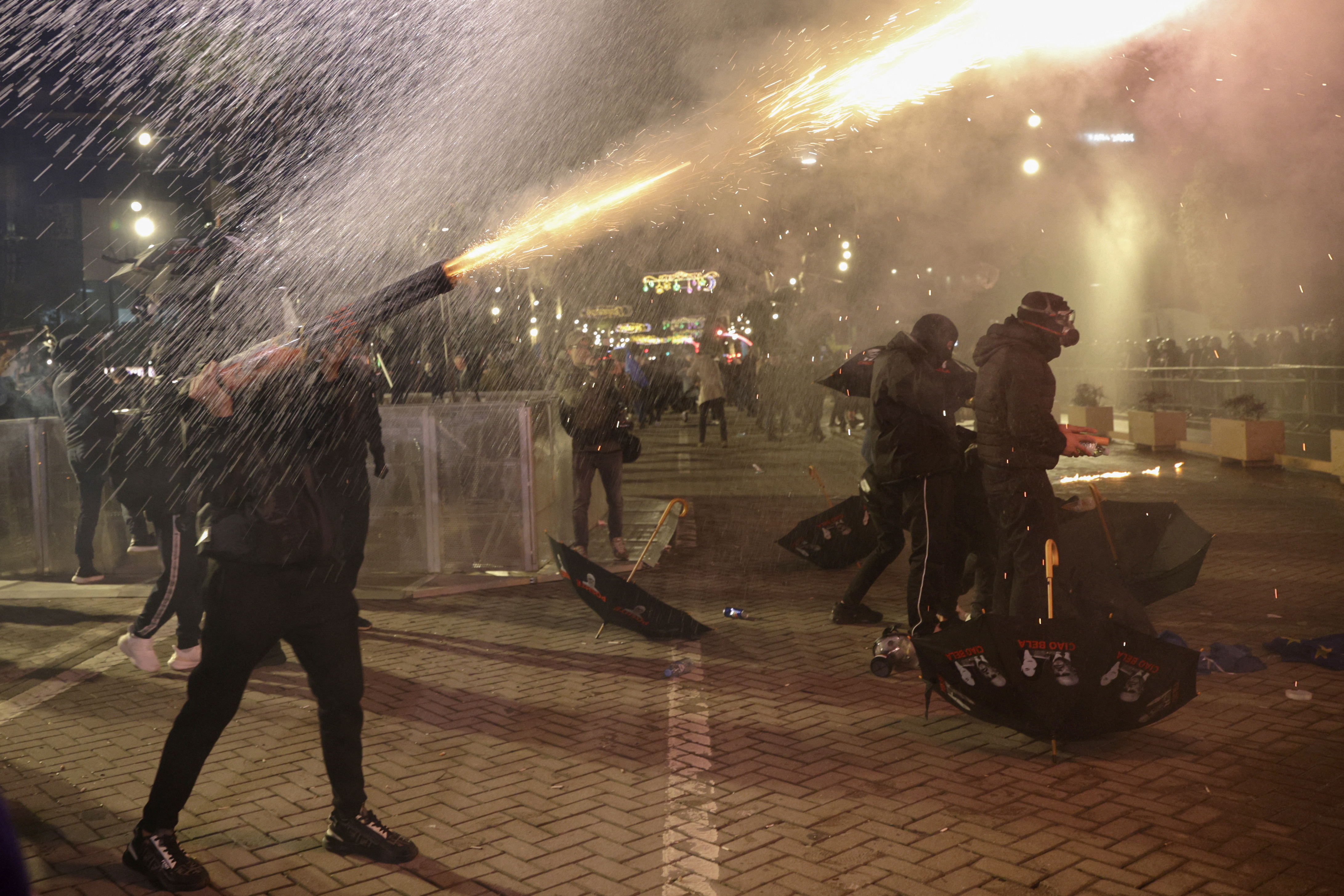 Protestors shoot fireworks towards anti-riot police during anti-government protests in front of the parliament building in Tirana on February 20, 2026.