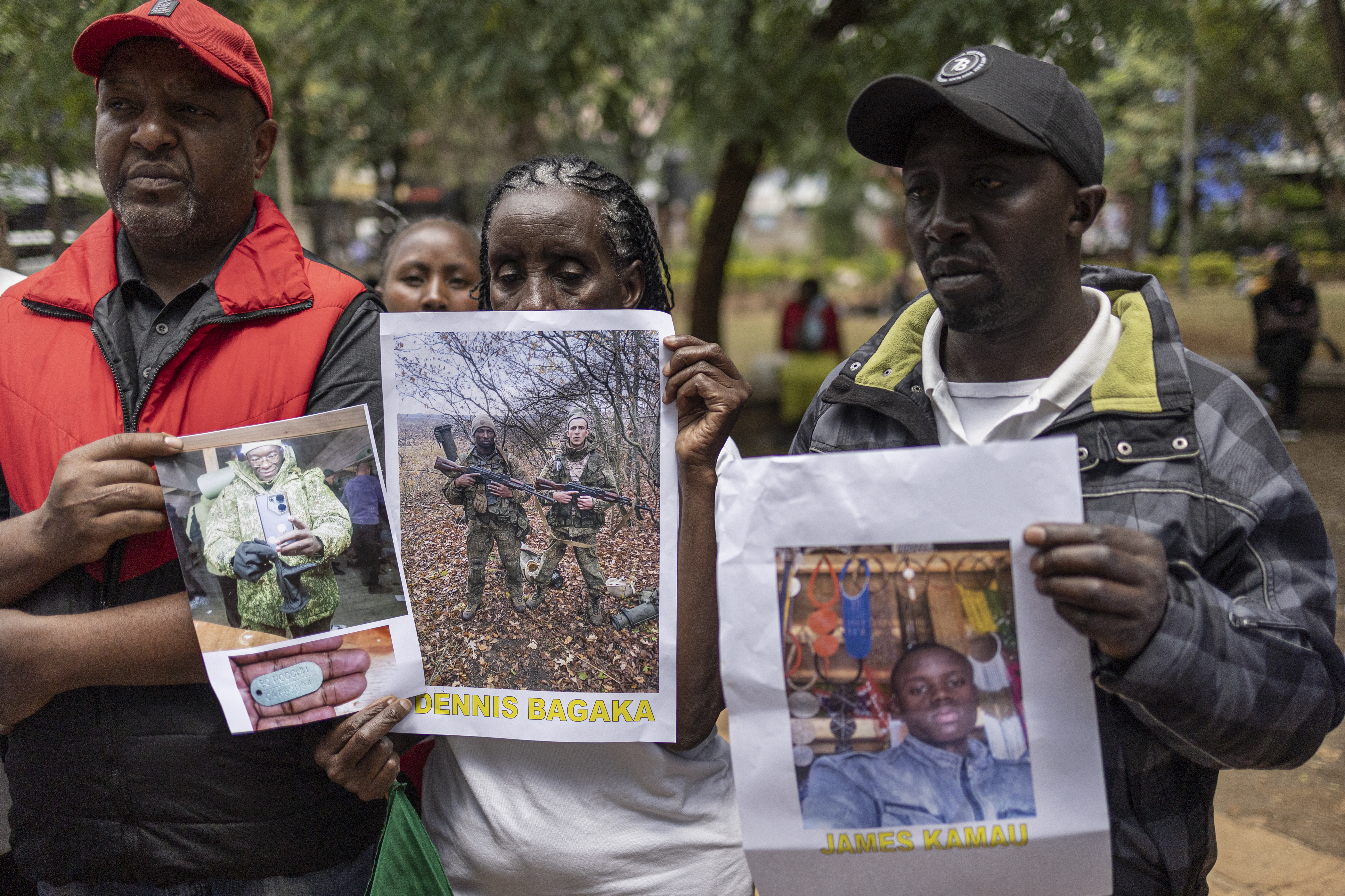 Relatives of Kenyan nationals conscripted by the Russian army in Ukraine pose with photos of their family members during a prayer and peaceful demonstration demanding urgent government action to repatriate their kin, in Nairobi on February 19, 2026.