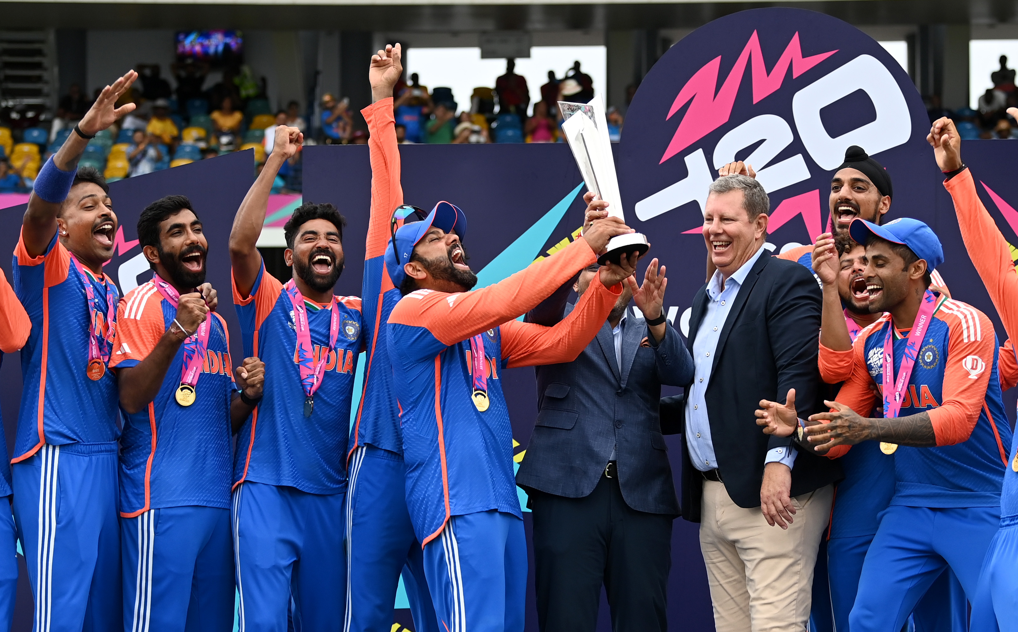 BRIDGETOWN, BARBADOS - JUNE 29: Rohit Sharma of India lifts the ICC Men's T20 Cricket World Cup Trophy following the ICC Men's T20 Cricket World Cup West Indies & USA 2024 Final match between South Africa and India at Kensington Oval on June 29, 2024 in Bridgetown, Barbados. (Photo by Gareth Copley/Getty Images)