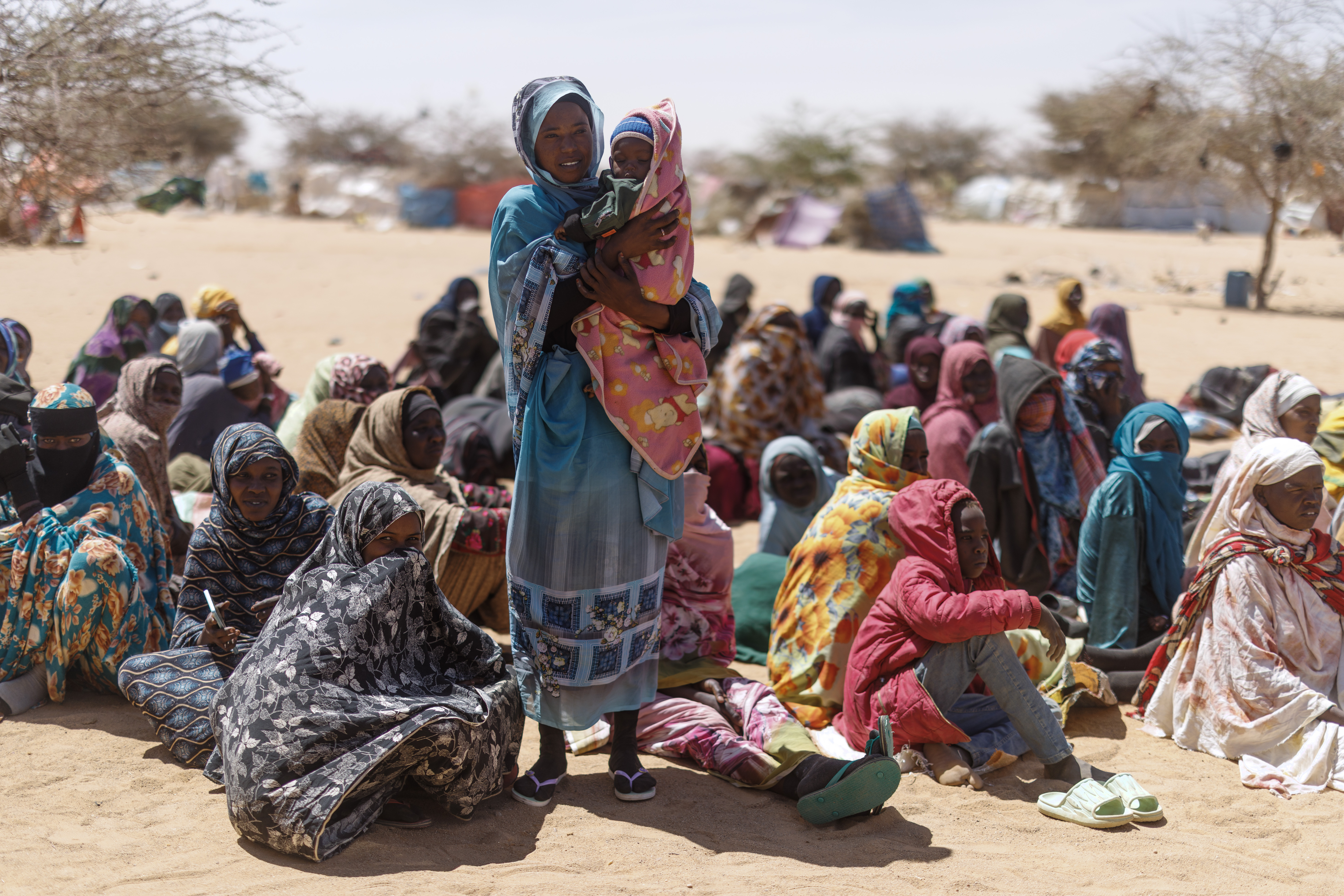 Sudanese refugees wait to be given aid.