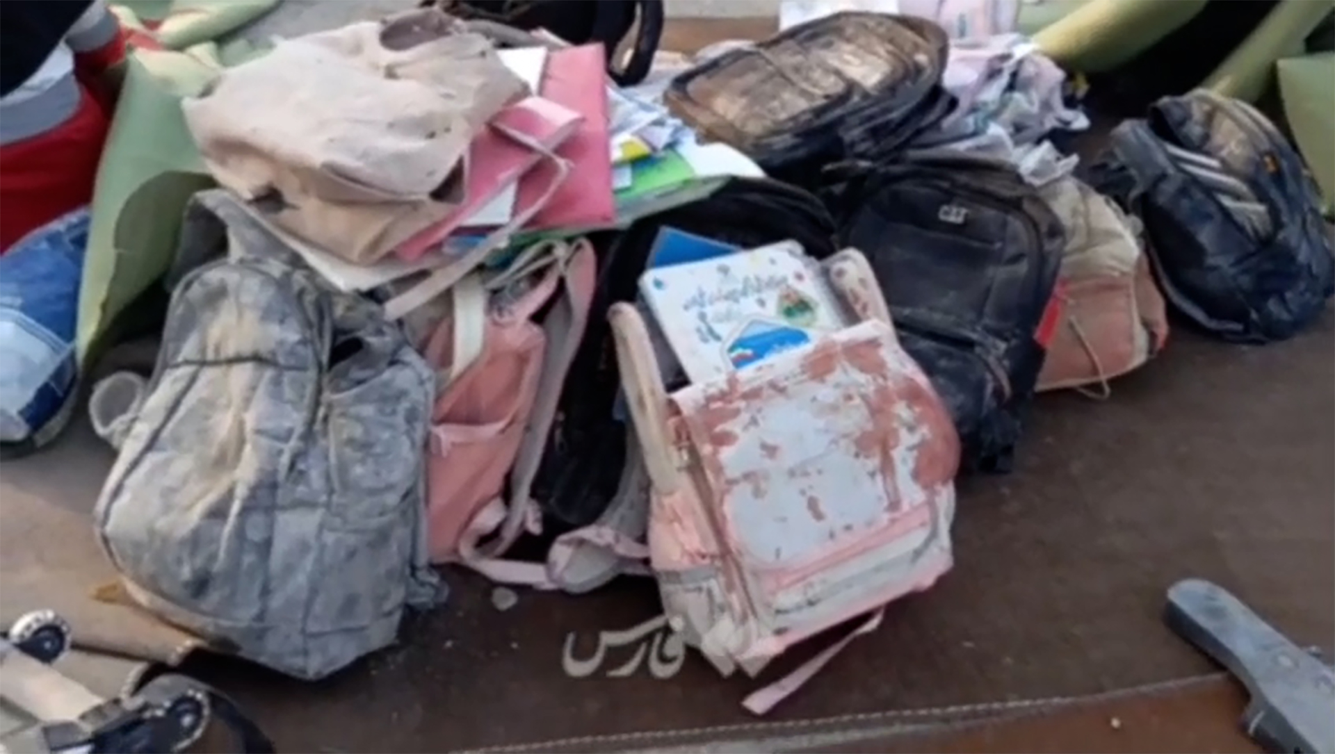 Backpacks are seen on the ground at a girls' elementary school after a bombing.