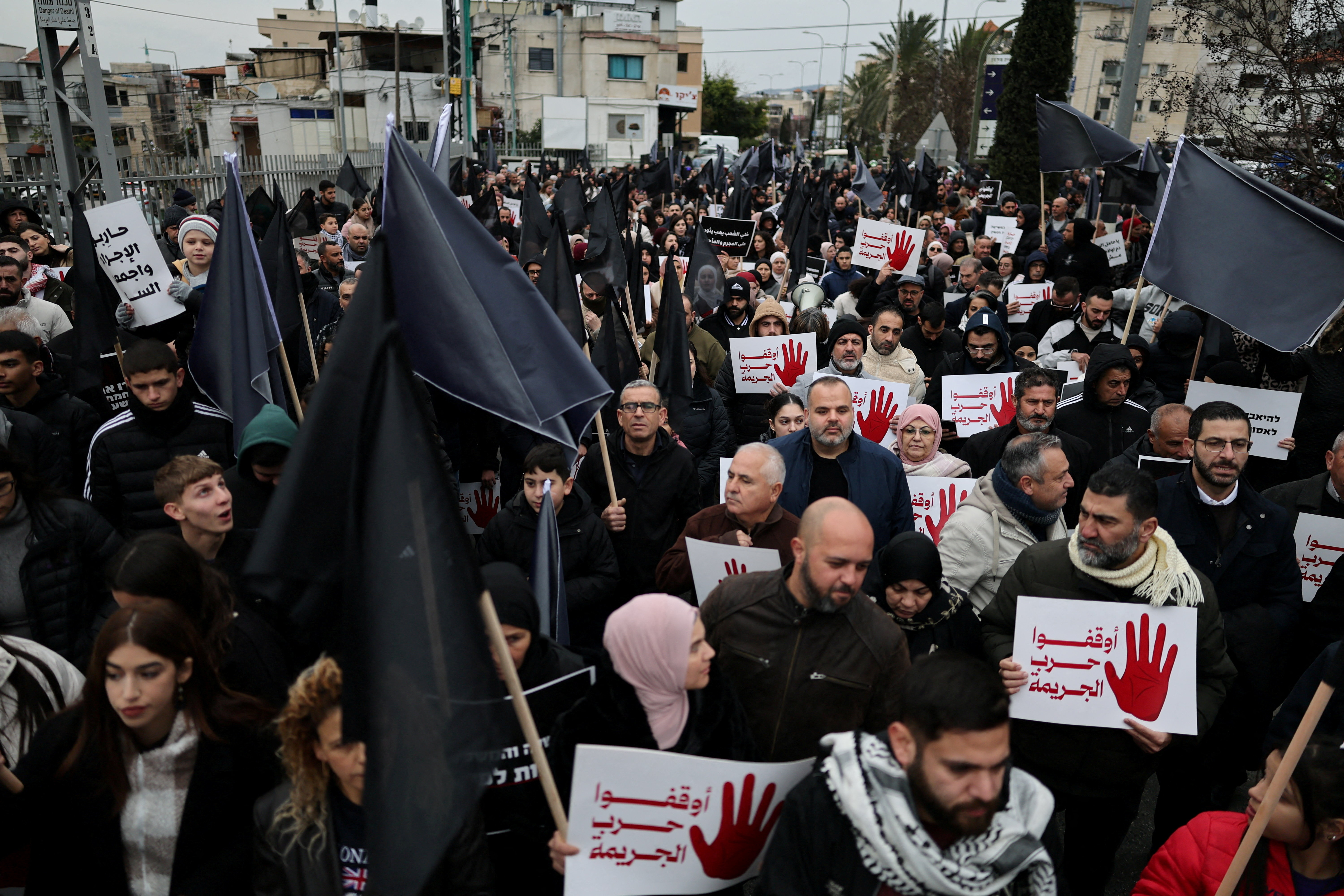 Members of Israel's Arab minority protest, calling on the Israeli government to tackle a wave of crime and killings from within Arab communities through effective law and order, in Sakhnin, northern Israel, January 22, 2026. REUTERS/Ammar Awad REFILE - CORRECTING YEAR FROM "2025" TO "2026".