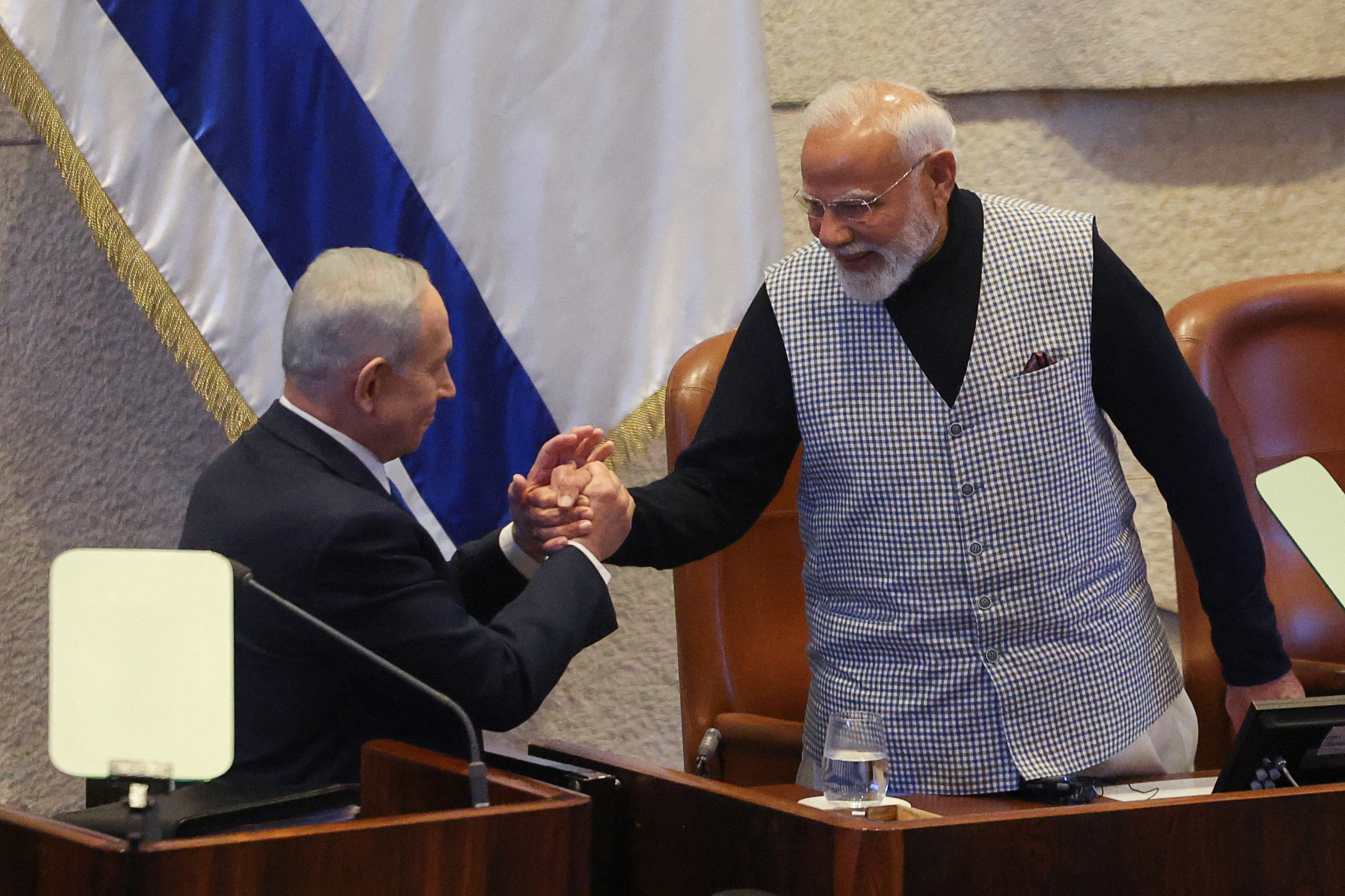 Israel's Prime Minister Benjamin Netanyahu greets Indian PM Narendra Modi during a special session of the Knesset