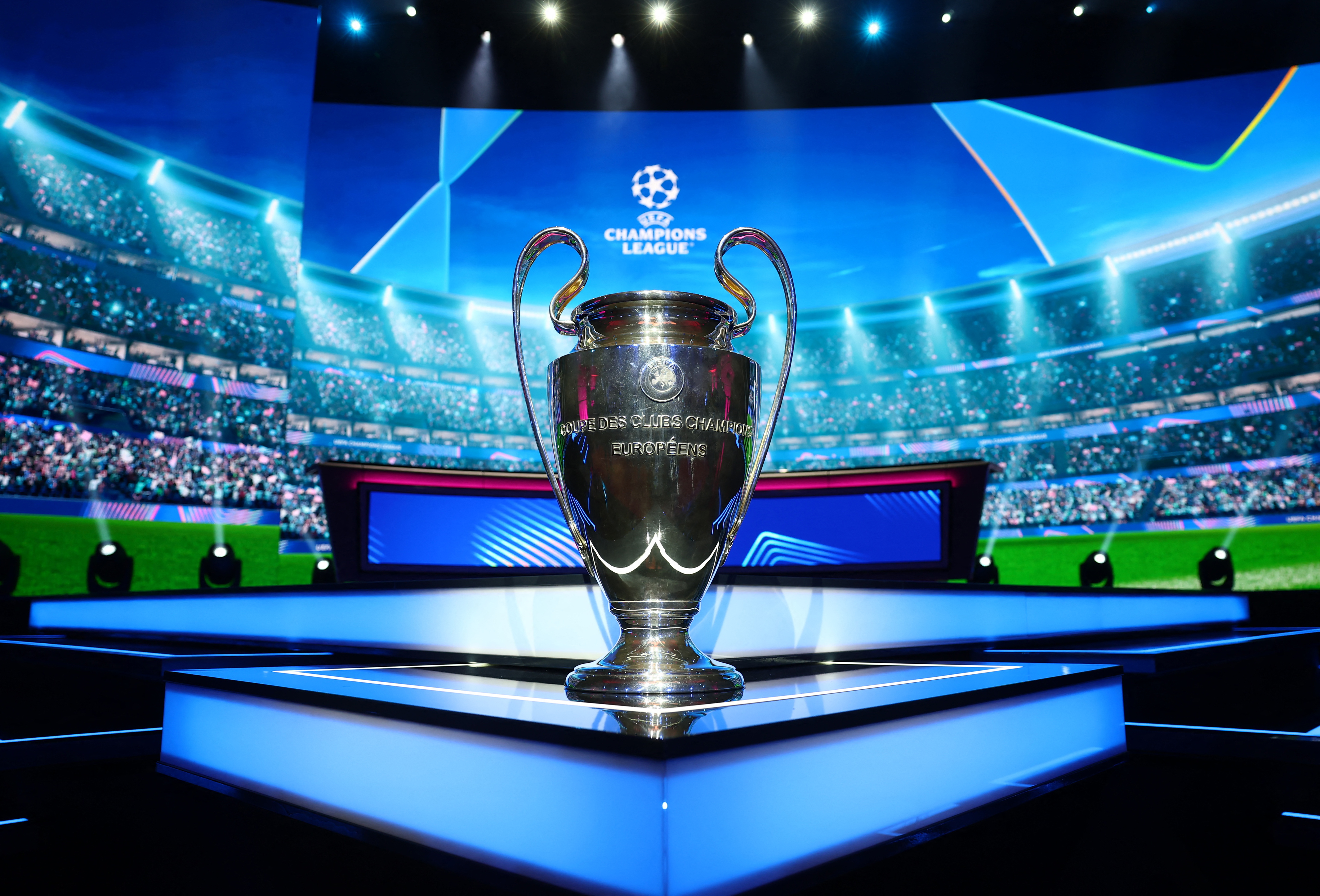 The UEFA Champions League trophy is displayed.