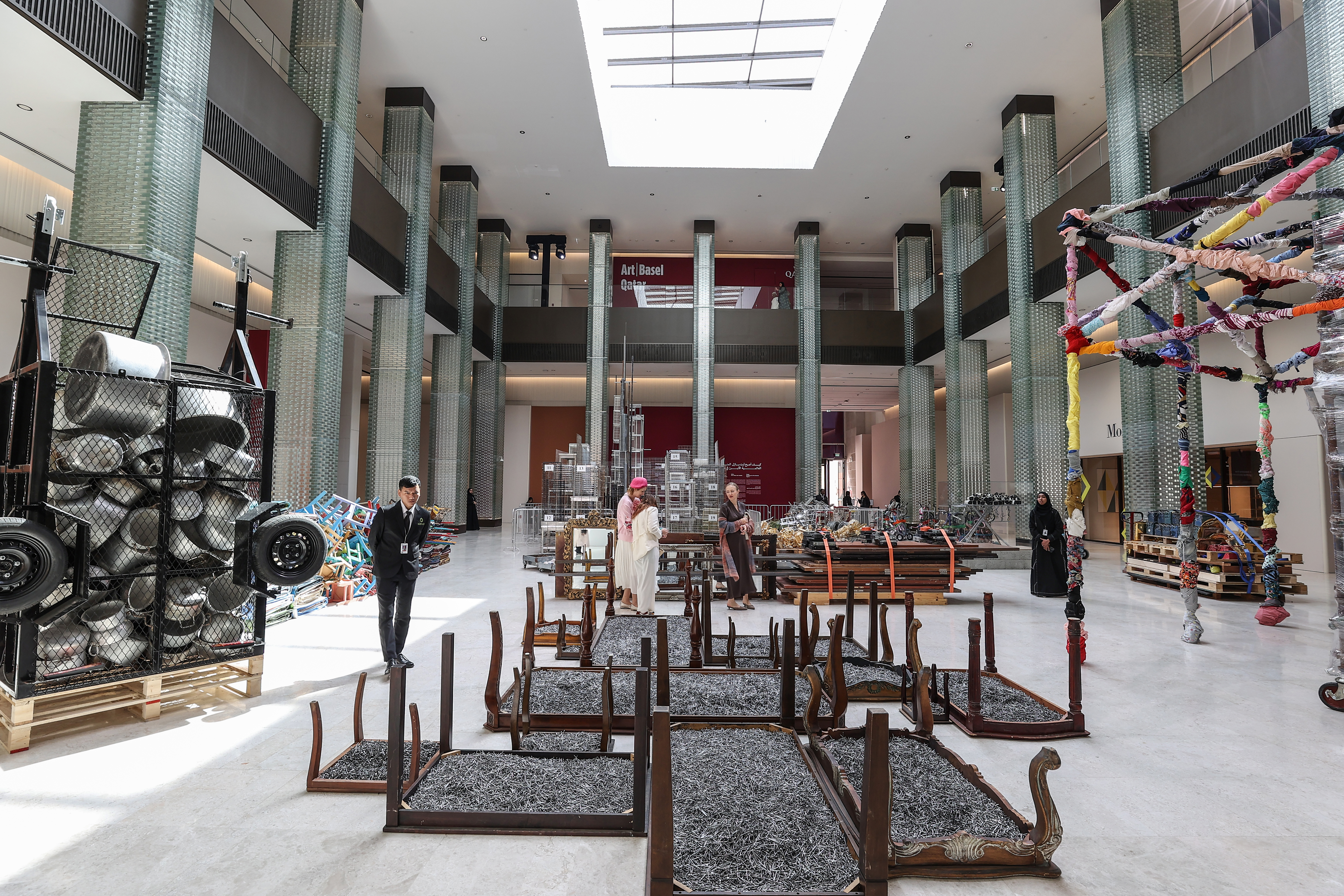 Visitors explore artworks and installations at the Art Basel Qatar Edition in Doha