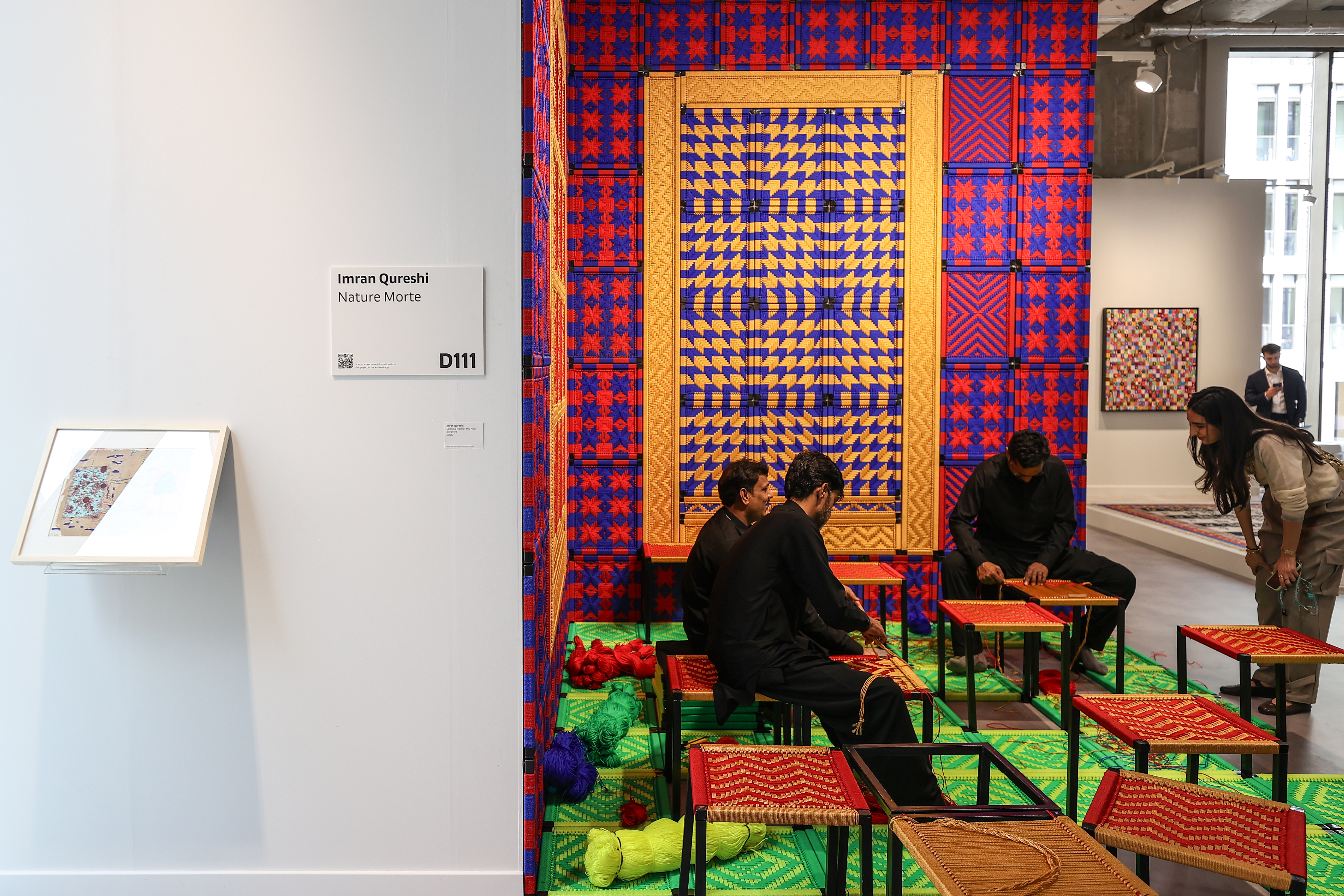 Visitors explore artworks and installations at the Art Basel Qatar Edition in Doha