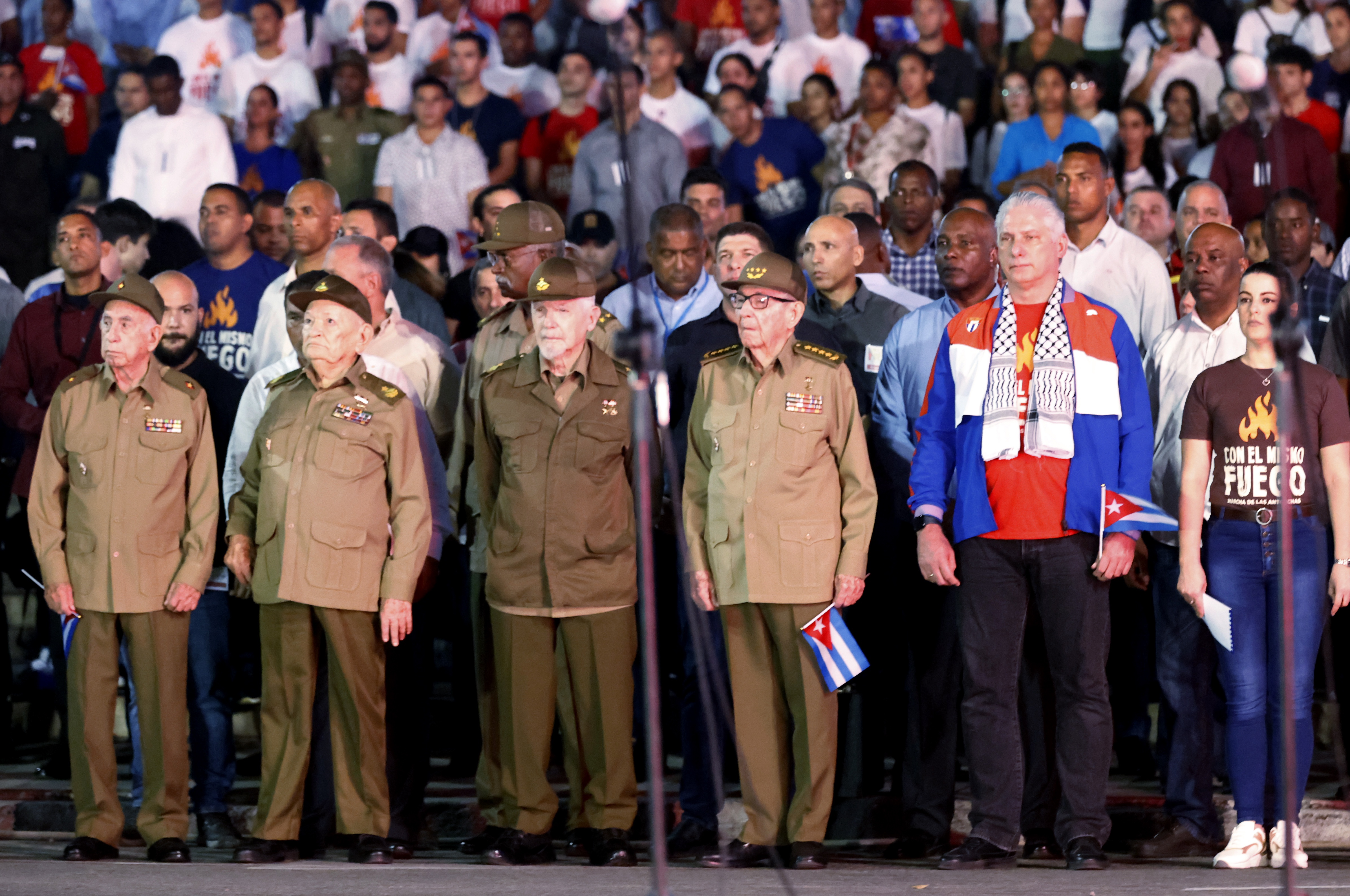 The president of Cuba, Miguel Díaz-Canel (2-R), and his predecessor, Raul Castro (3-R), together with commanders Jose Ramon Machado (L), Guillermo Garcia (2-L) and Ramiro Valdez (3-L), lead the traditional march of the torches to commemorate the 171st anniversary of the birth of the national hero Jose Marti 