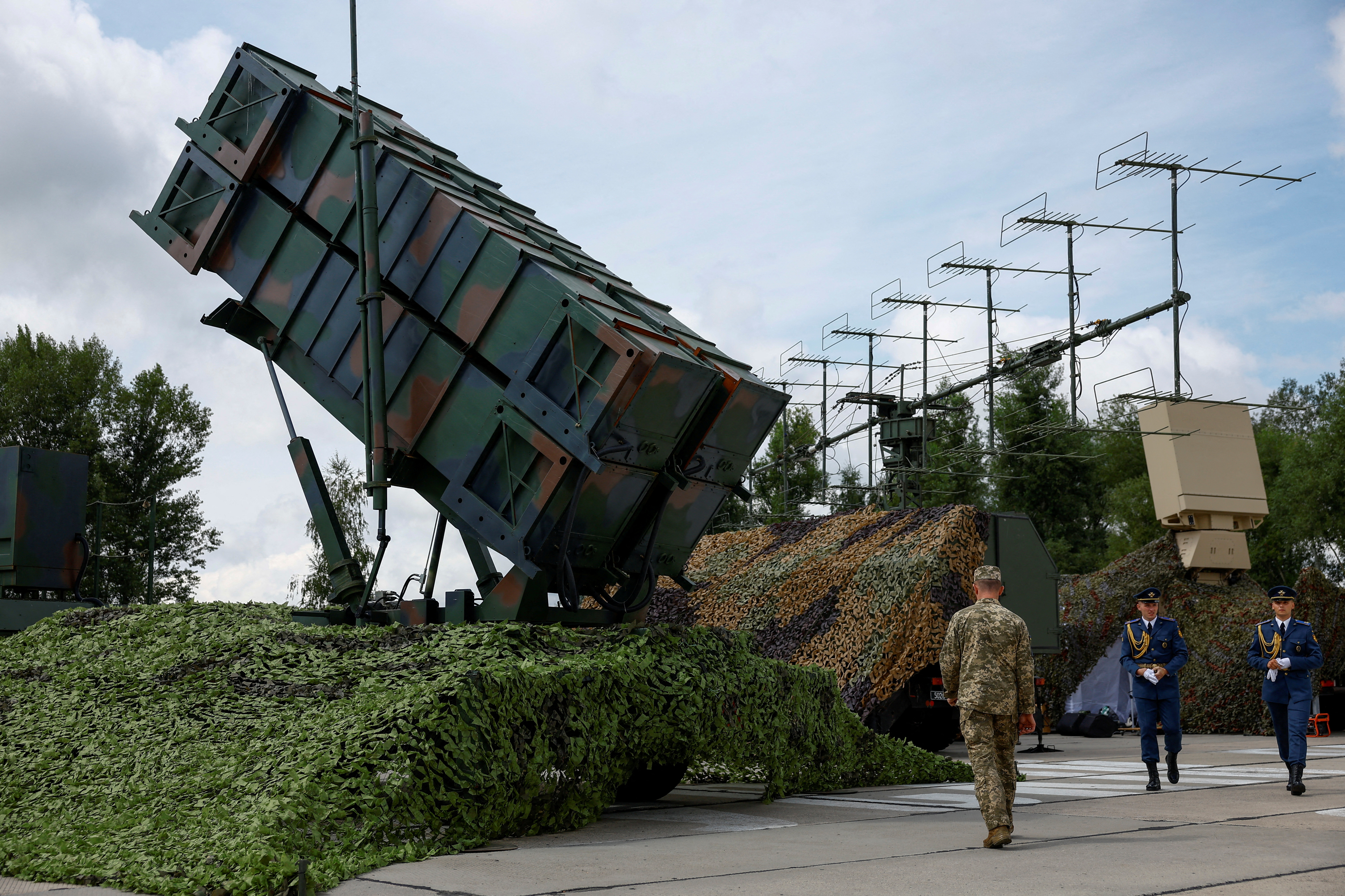 FILE PHOTO: Ukrainian service members walk next to a launcher of a Patriot air defence system, amid Russia's attack on Ukraine, in an undisclosed location, Ukraine August 4, 2024. REUTERS/Valentyn Ogirenko/File Photo