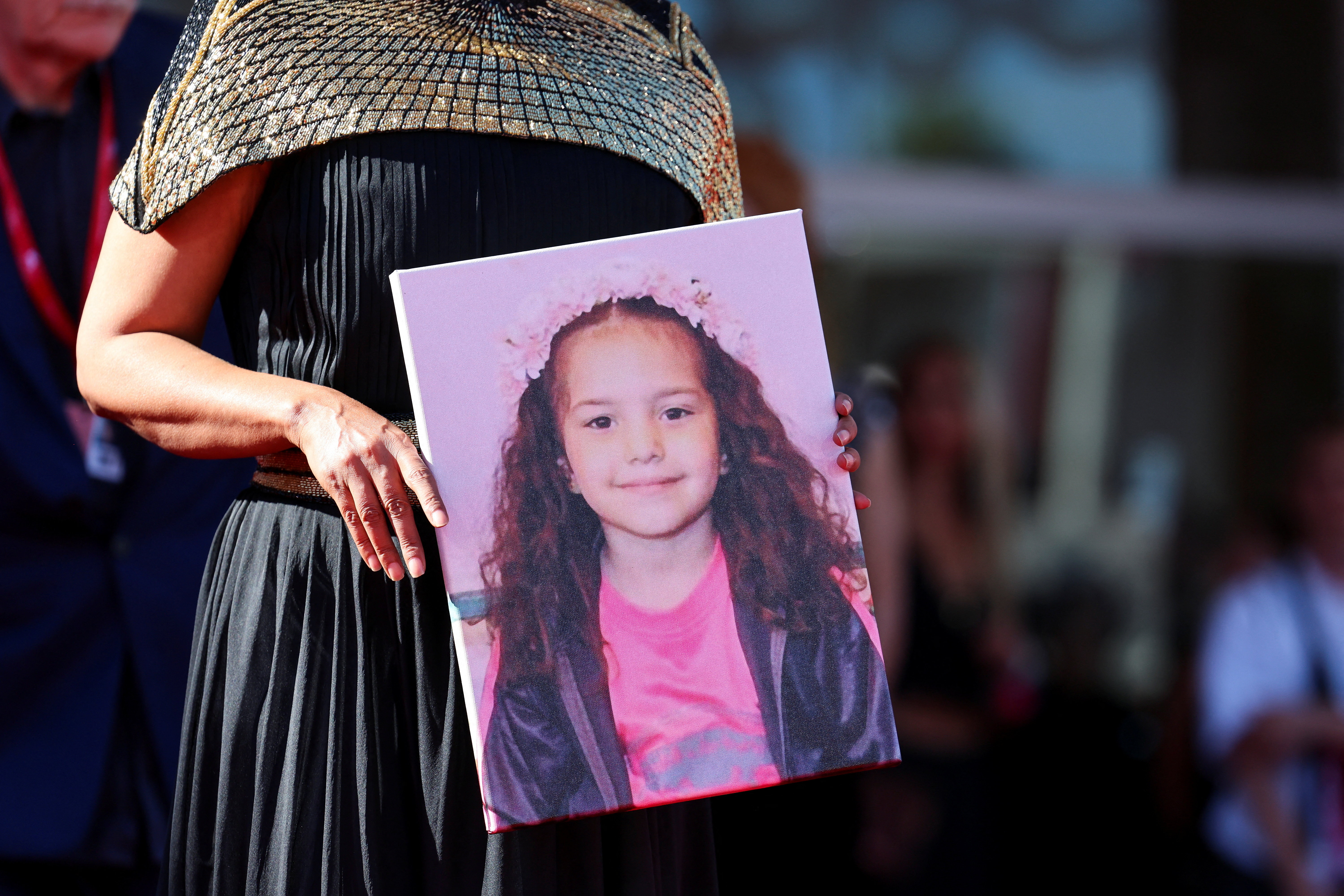 Kaouther Ben Hania holds a picture of Hind Rajab on the red carpet during arrivals for the screening "The Voice of Hind Rajab" in competition, at the 82nd Venice Film Festival, Venice, Italy, September 3, 2025. REUTERS/Yara Nardi