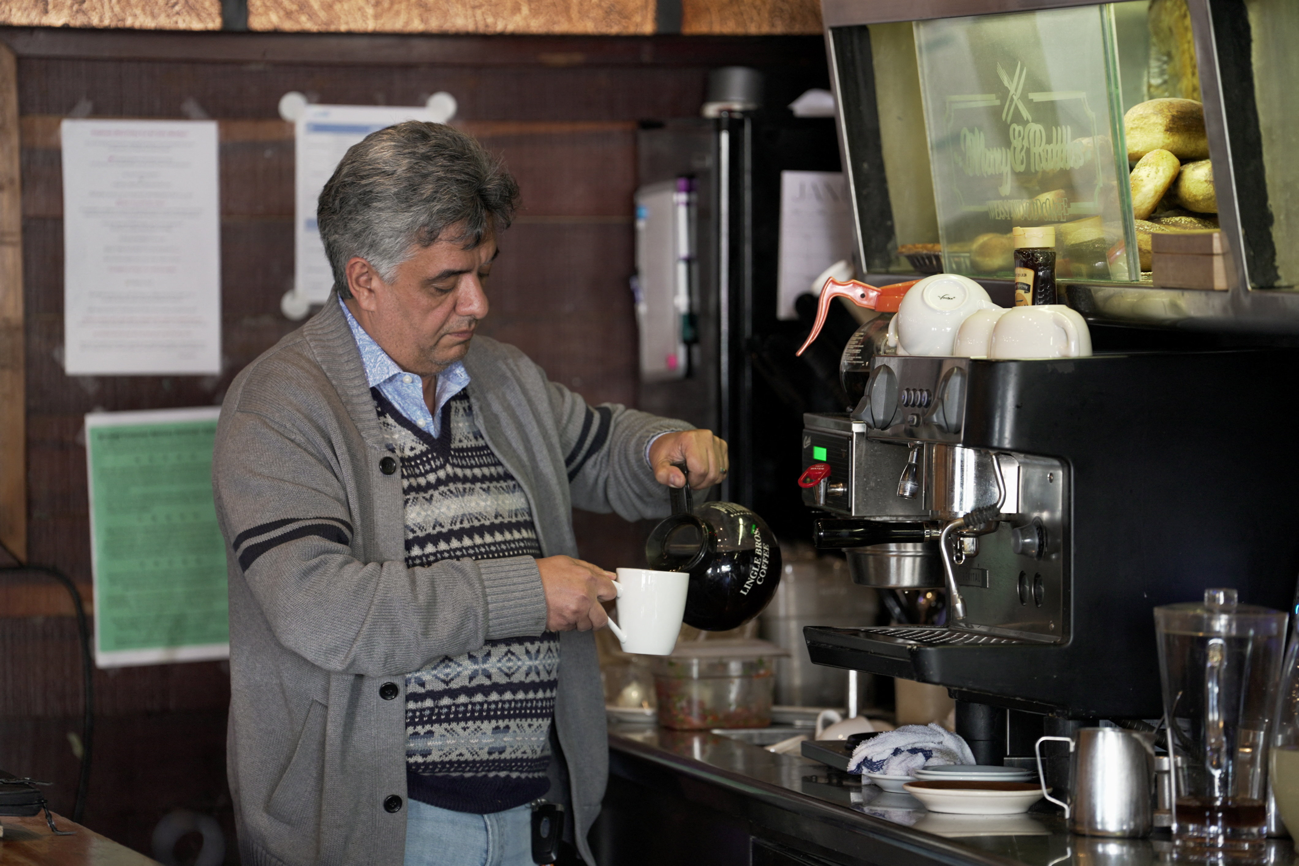 Roozbeh Farahanipour, an Iranian-American activist, prepares coffee inside his restaurant, Mary & Robbs Westwood Cafe, in Los Angeles, California, U.S., January 12, 2026. REUTERS/Arafat Barbakh