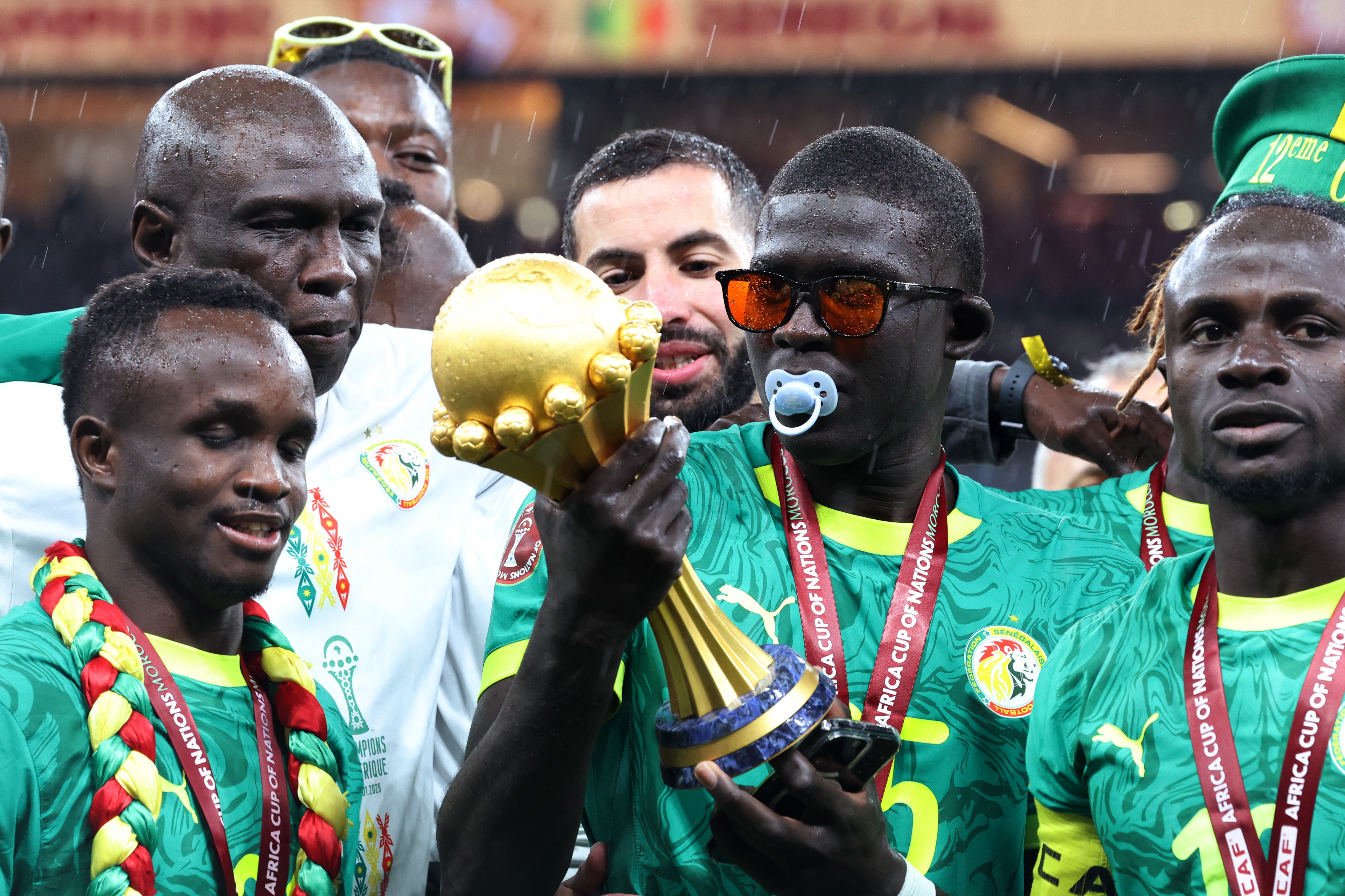Soccer Football - CAF Africa Cup of Nations - Morocco 2025 - Final - Senegal v Morocco - Prince Moulay Abdellah Stadium, Rabat, Morocco - January 18, 2026 Senegal's El Hadji Malick Diouf celebrates with the trophy after winning the Africa Cup of Nations REUTERS/Amr Abdallah Dalsh