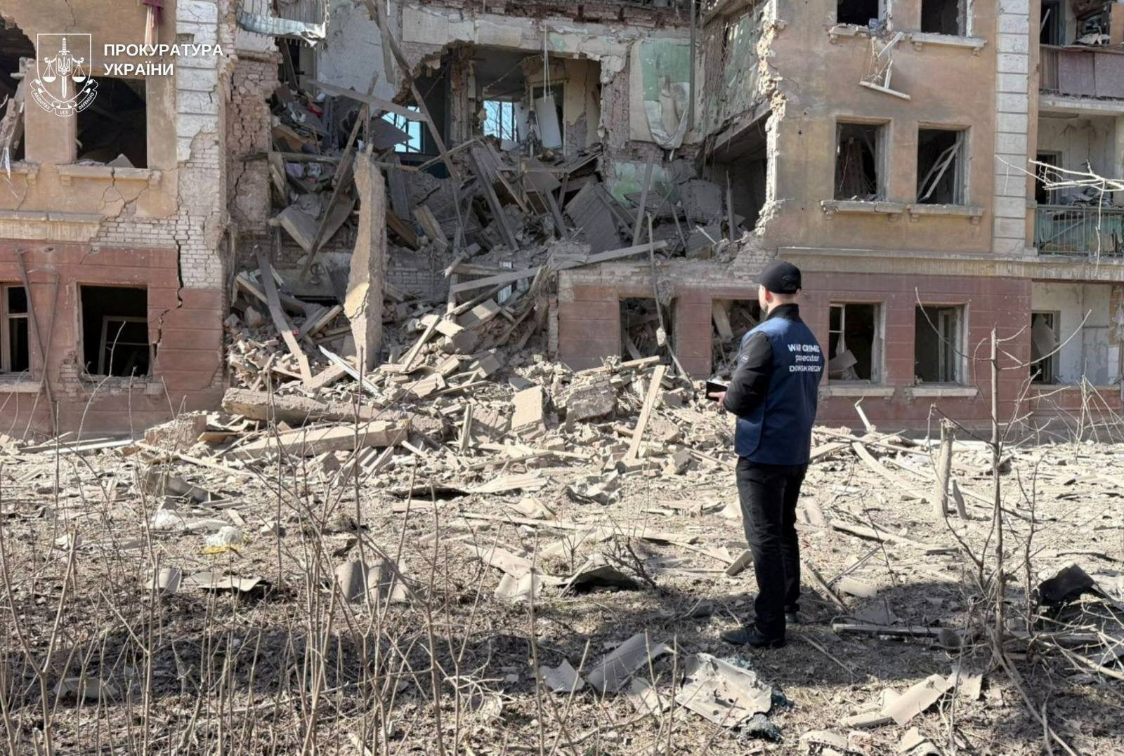 A war crimes prosecutor works at a site of a Russian air strike