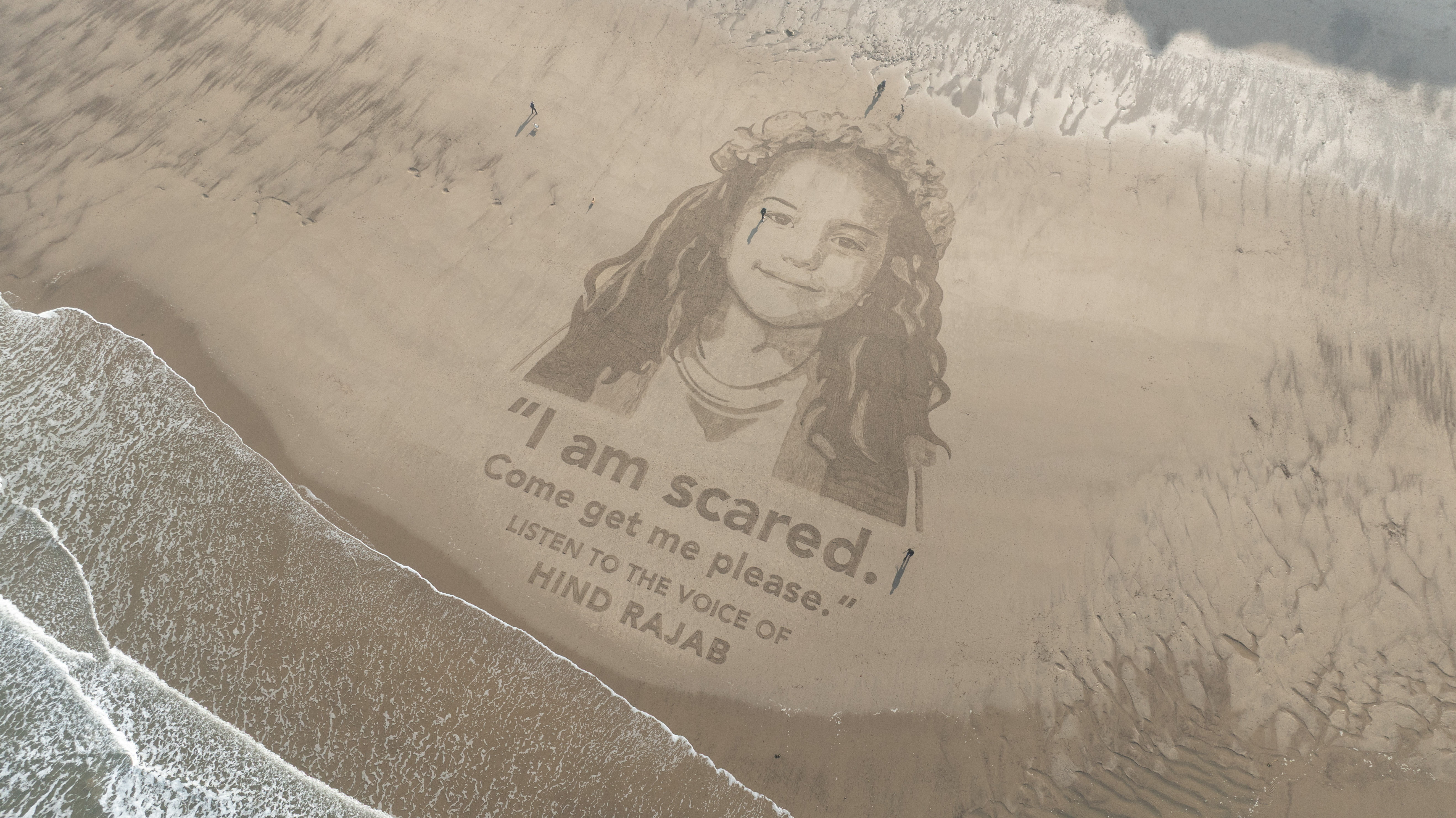 Drone view of a giant sand portrait of Hind Rajab