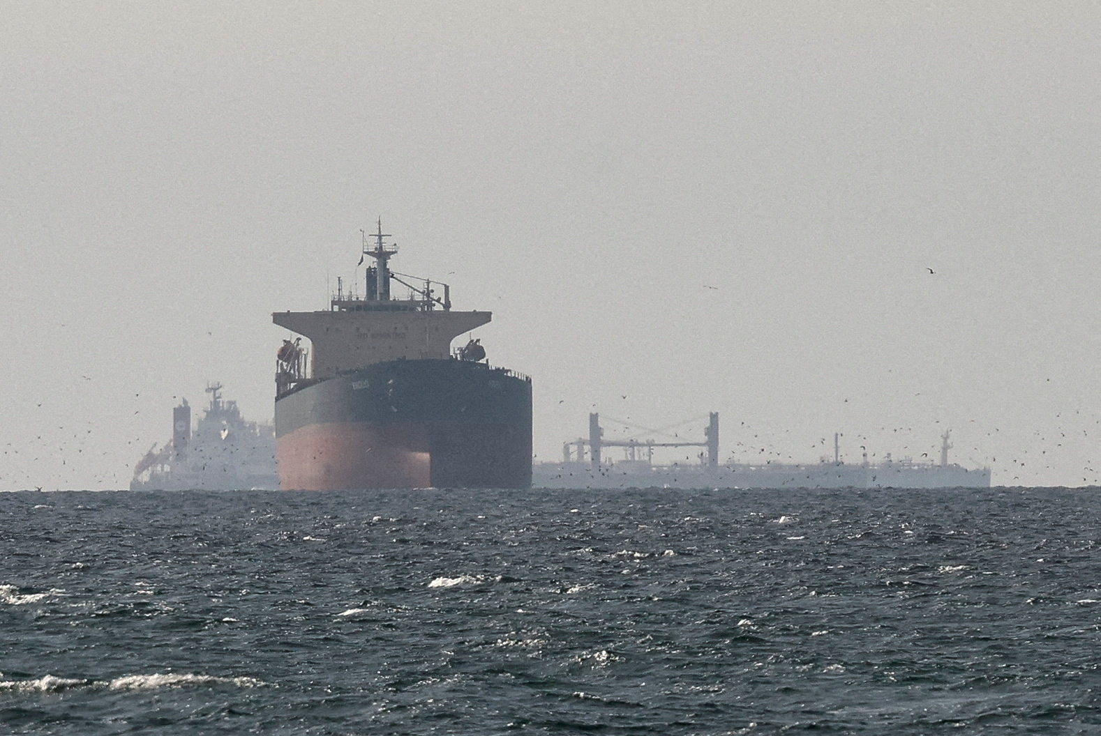 Tankers sail at sea.