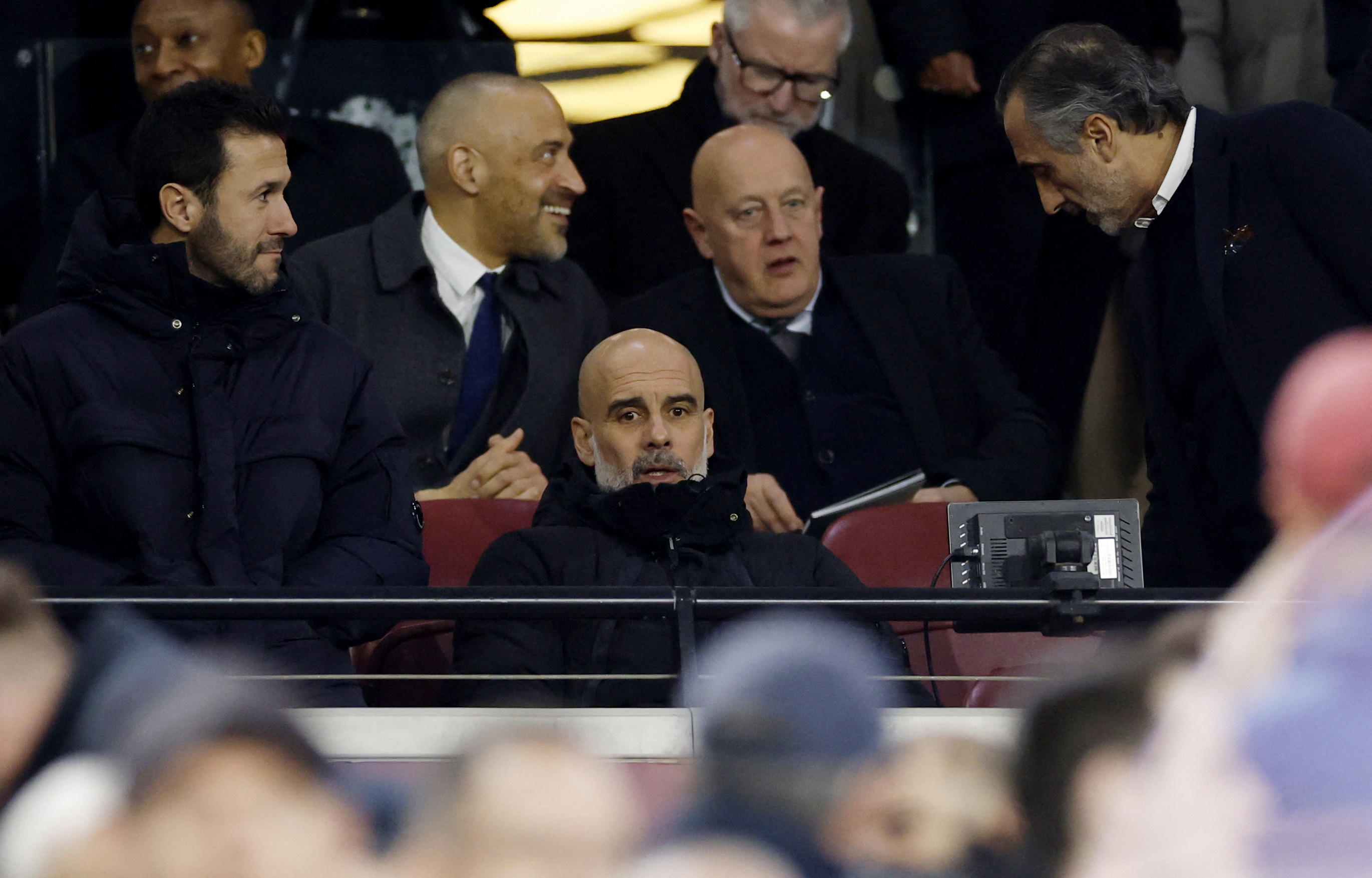 Manchester City manager Pep Guardiola sits in the stand