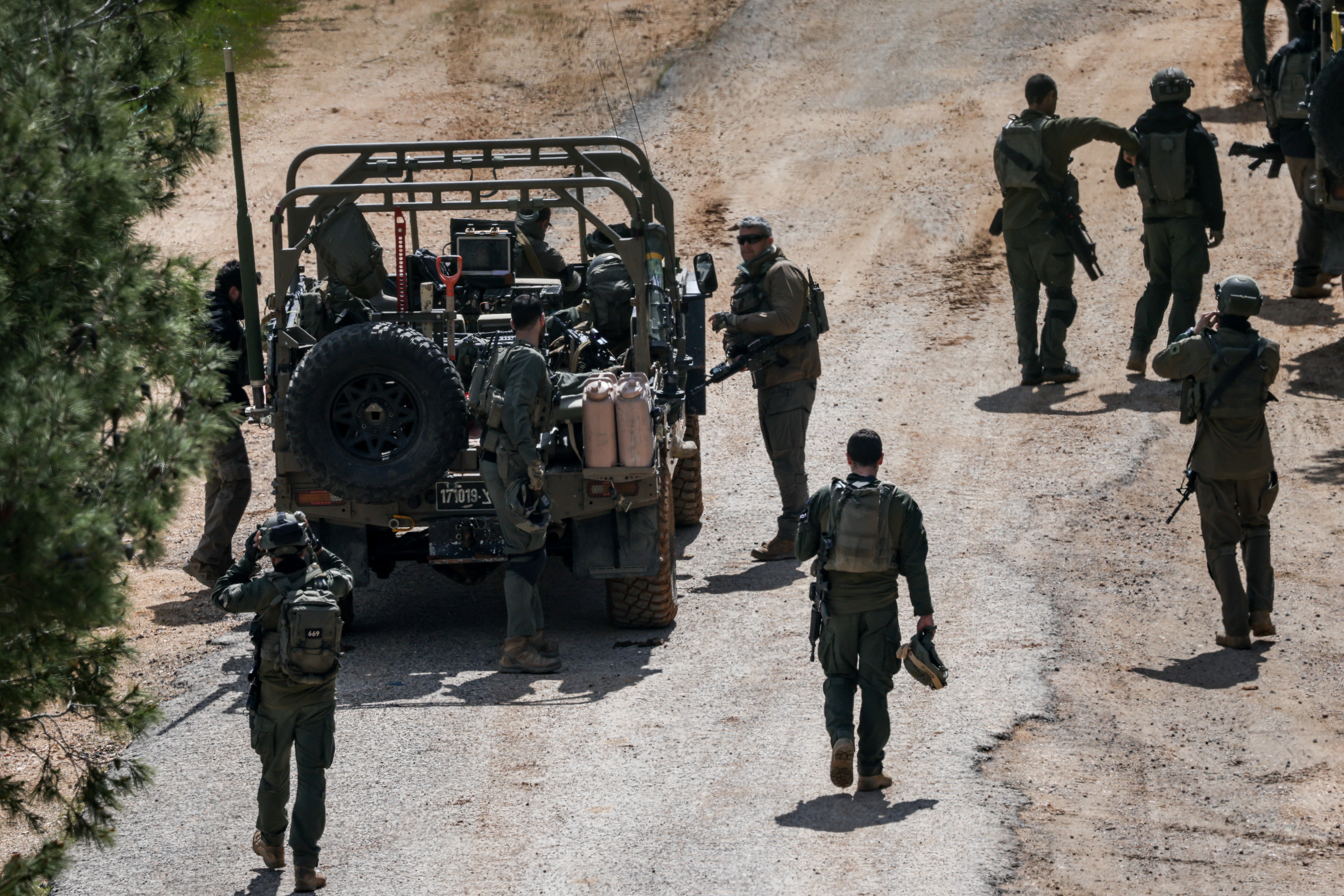 Israeli soldiers gather on the Israeli side of the border with Lebanon