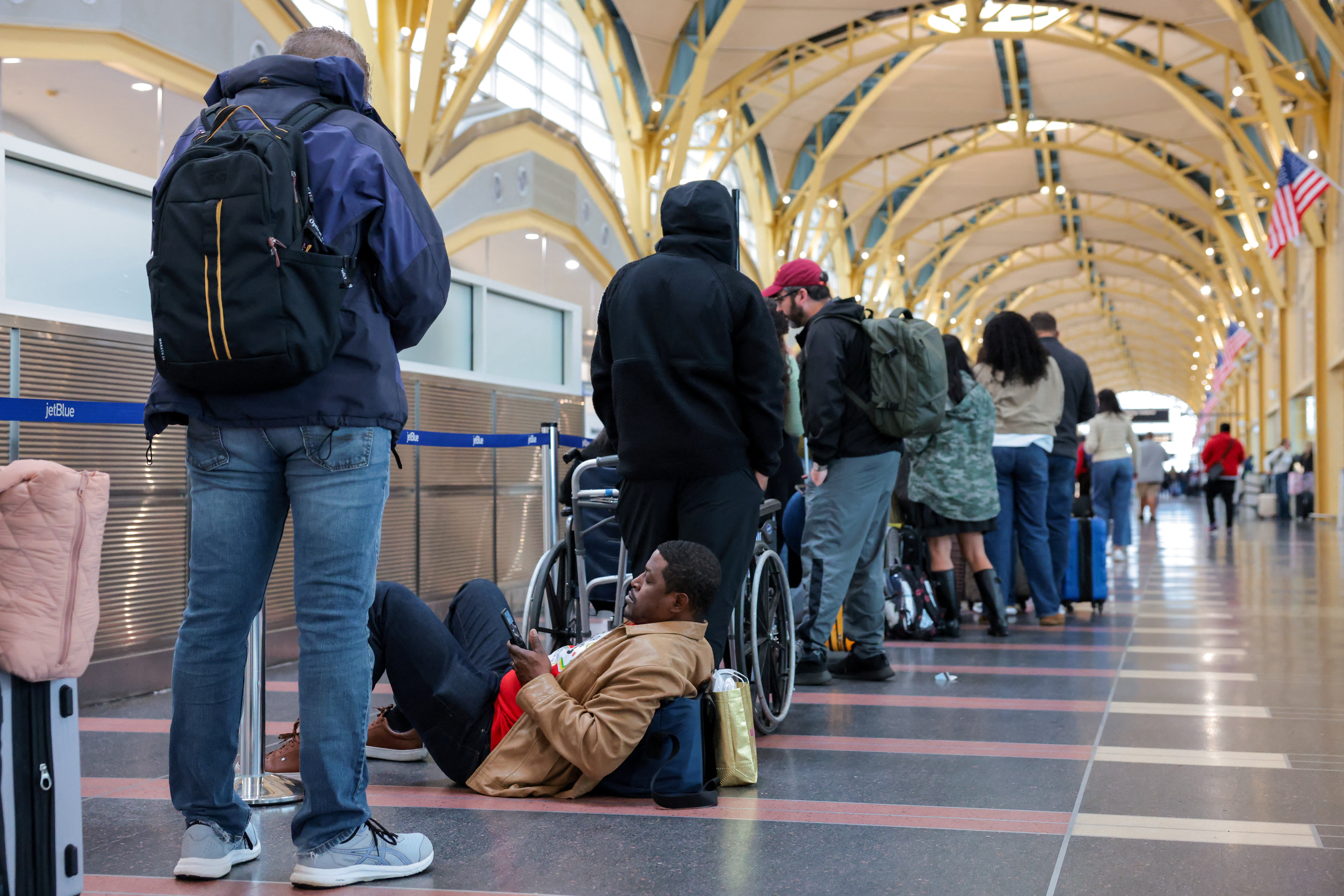 Passengers wait in a check-in line at Ronald Reagan Washington National Airport