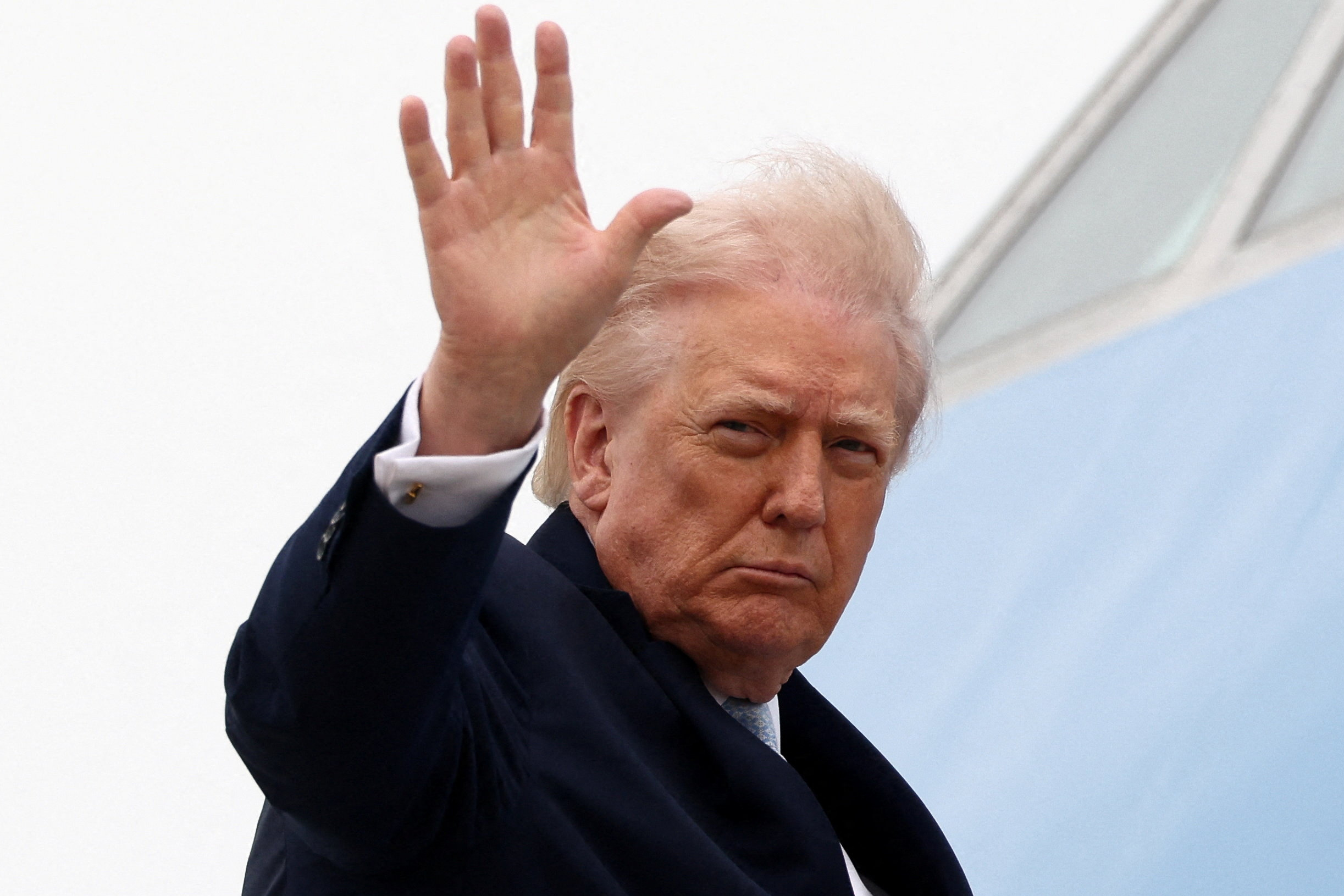 U.S. President Donald Trump gestures while boarding Air Force One as he departs from Joint Base Andrews in Maryland, U.S., March 20, 2026.