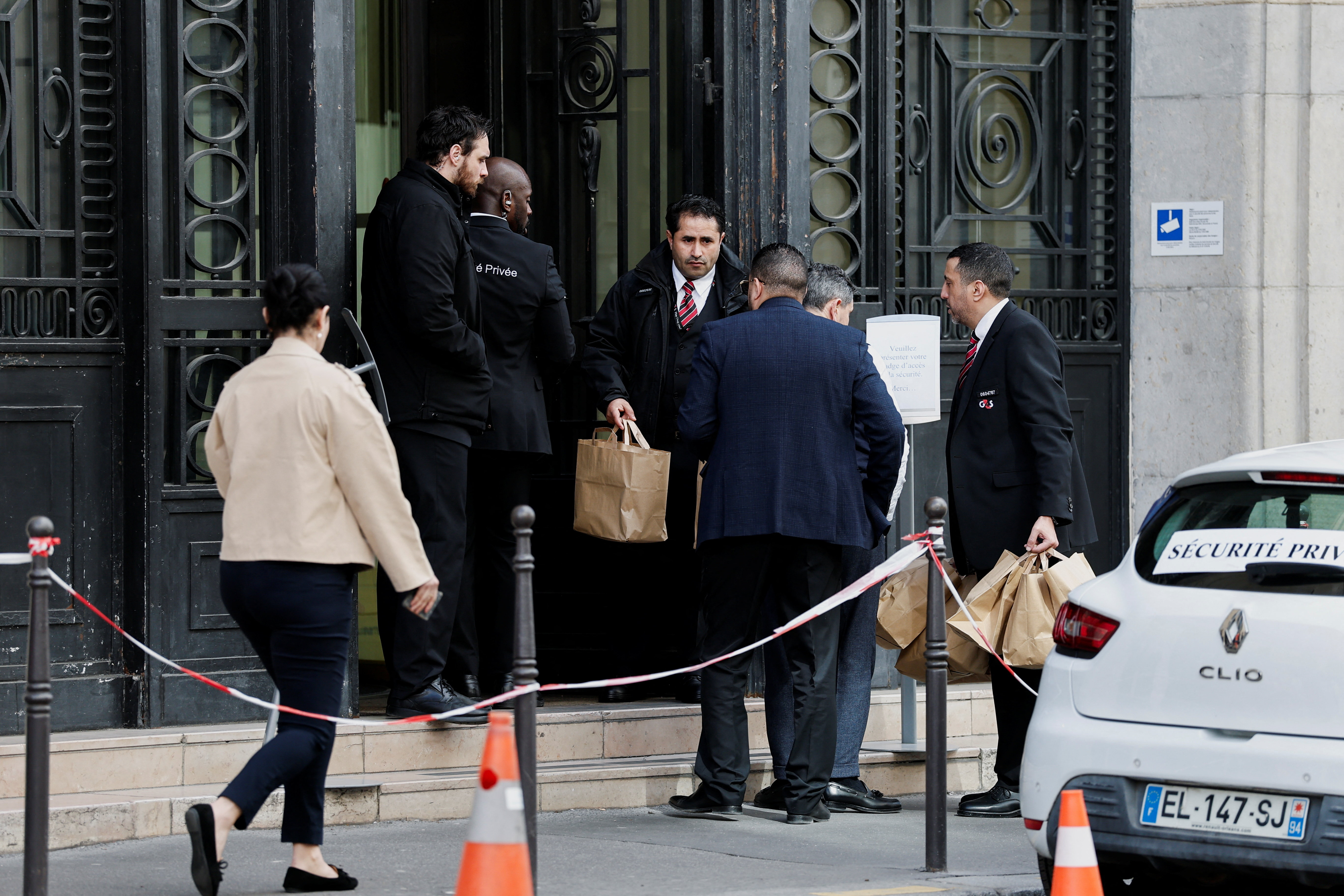 Private security members work outside Bank of America’s Paris offices