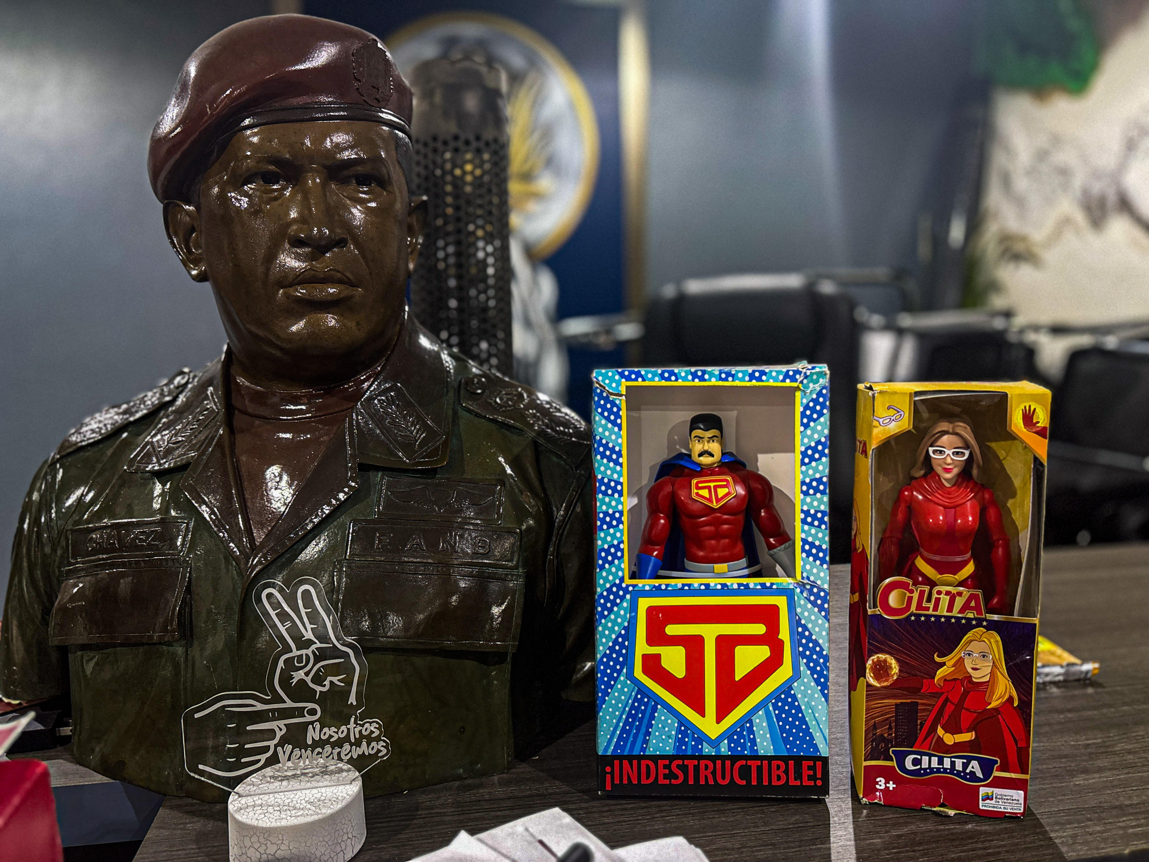 A statue of Hugo Chavez and action figures representing Nicolas Maduro and his wife Cilia Flores