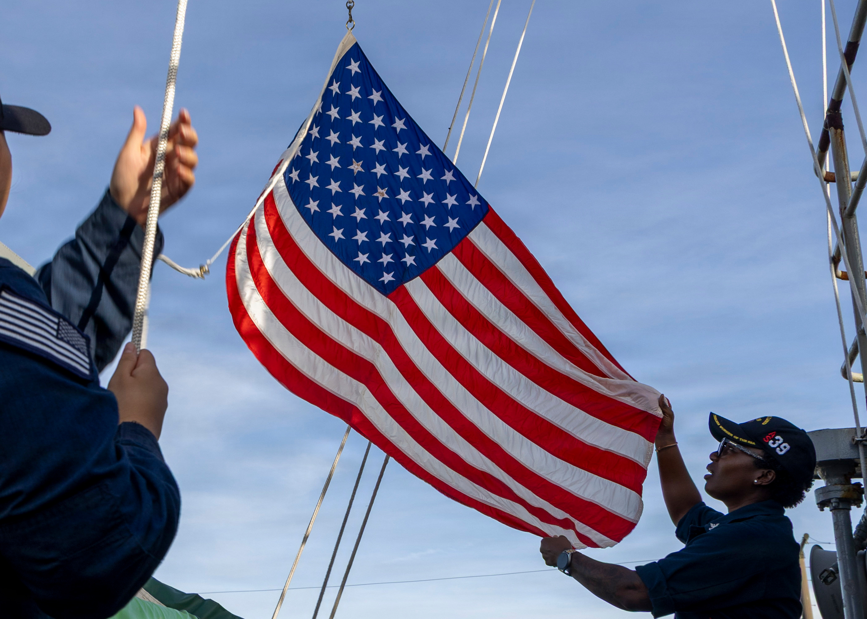 Sailors raised the U.S. flag aboard the submarine USS Emory S. Land
