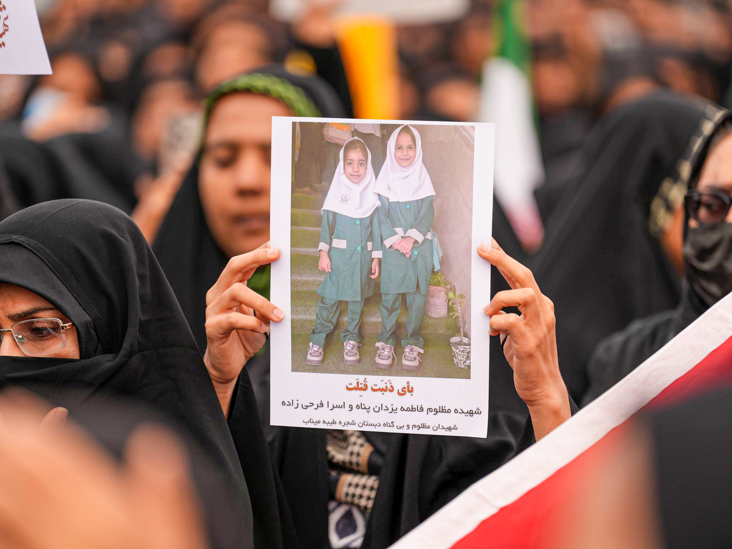 Mourners hold a portrait of a students during a funeral ceremony for children, who lost their lives after a primary school in Iran’s Hormozgan province was targeted in US and Israeli attacks, on March 03, 2026 in Minab, Iran