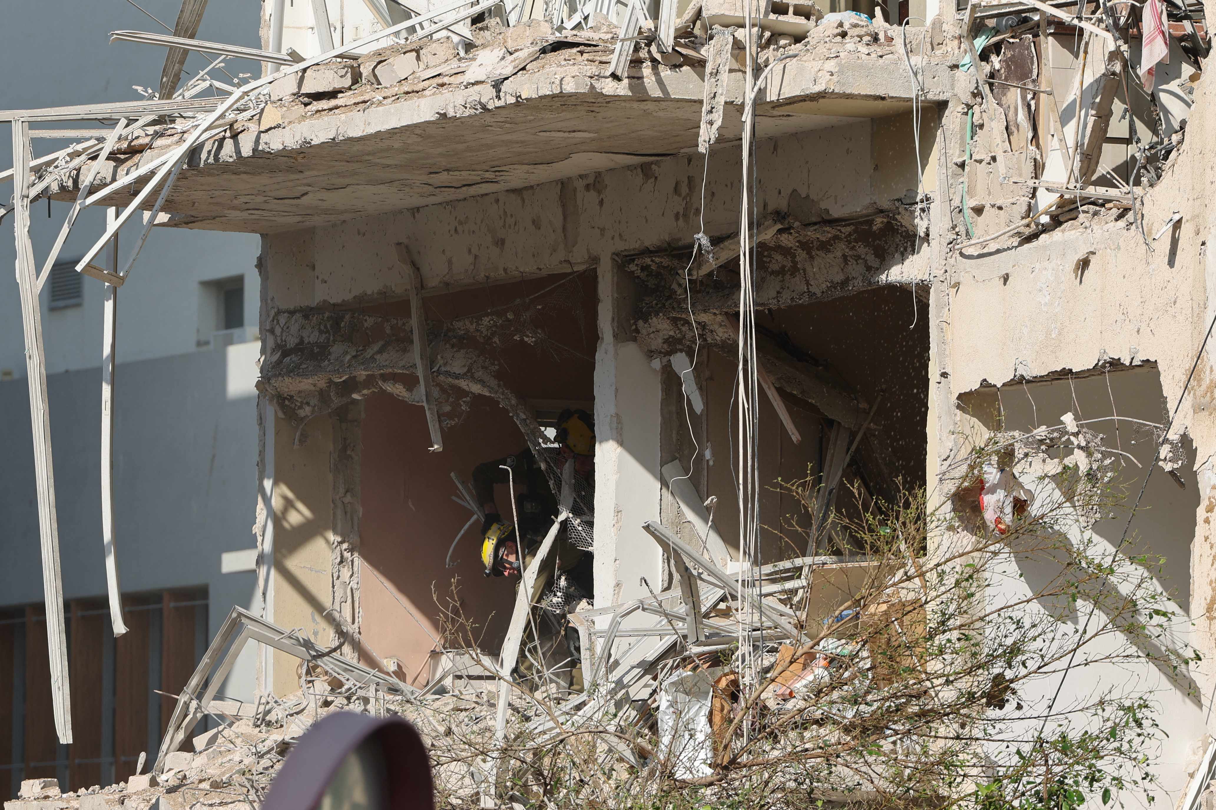 This picture shows damaged buildings at the site of an Iranian missile strike in Tel Aviv