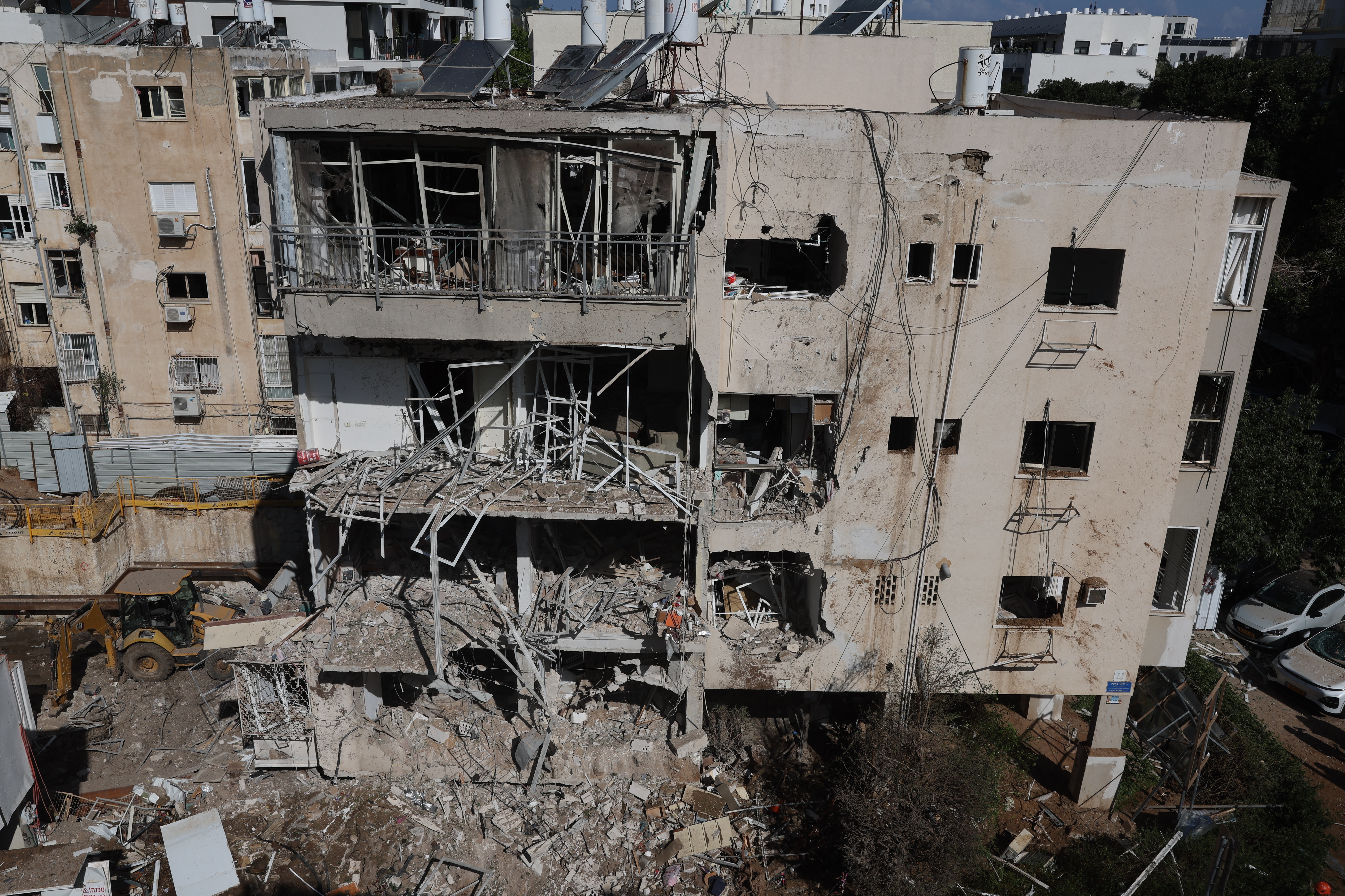 This picture shows damaged buildings at the site of an Iranian missile strike in Tel Aviv