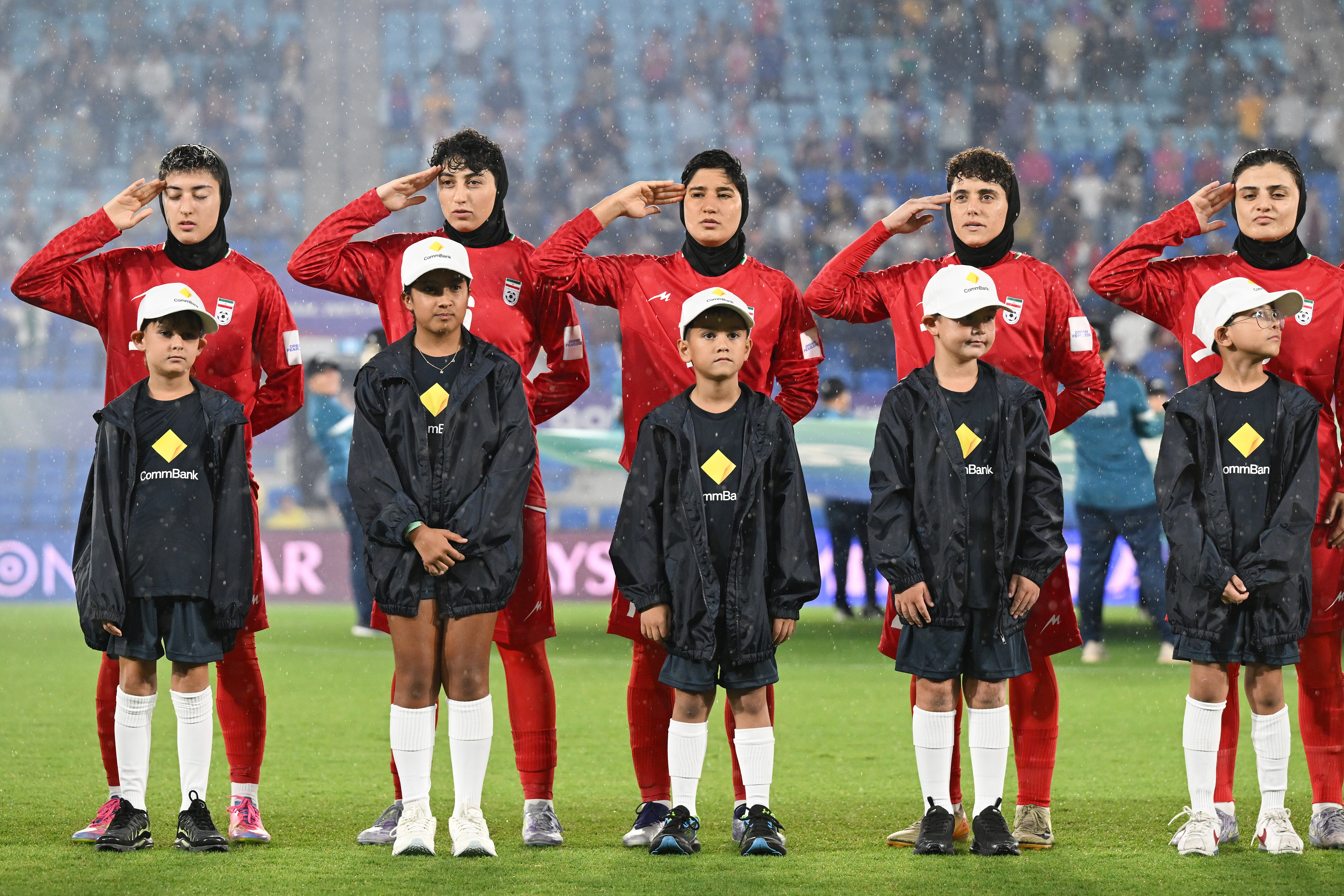 Iran players react during their national anthem ahead of the Women's Asian Cup soccer match between Iran and the Philippines in Robina, Australia, Sunday, March 8, 2026. (Dave Hunt/AAP Image via AP)