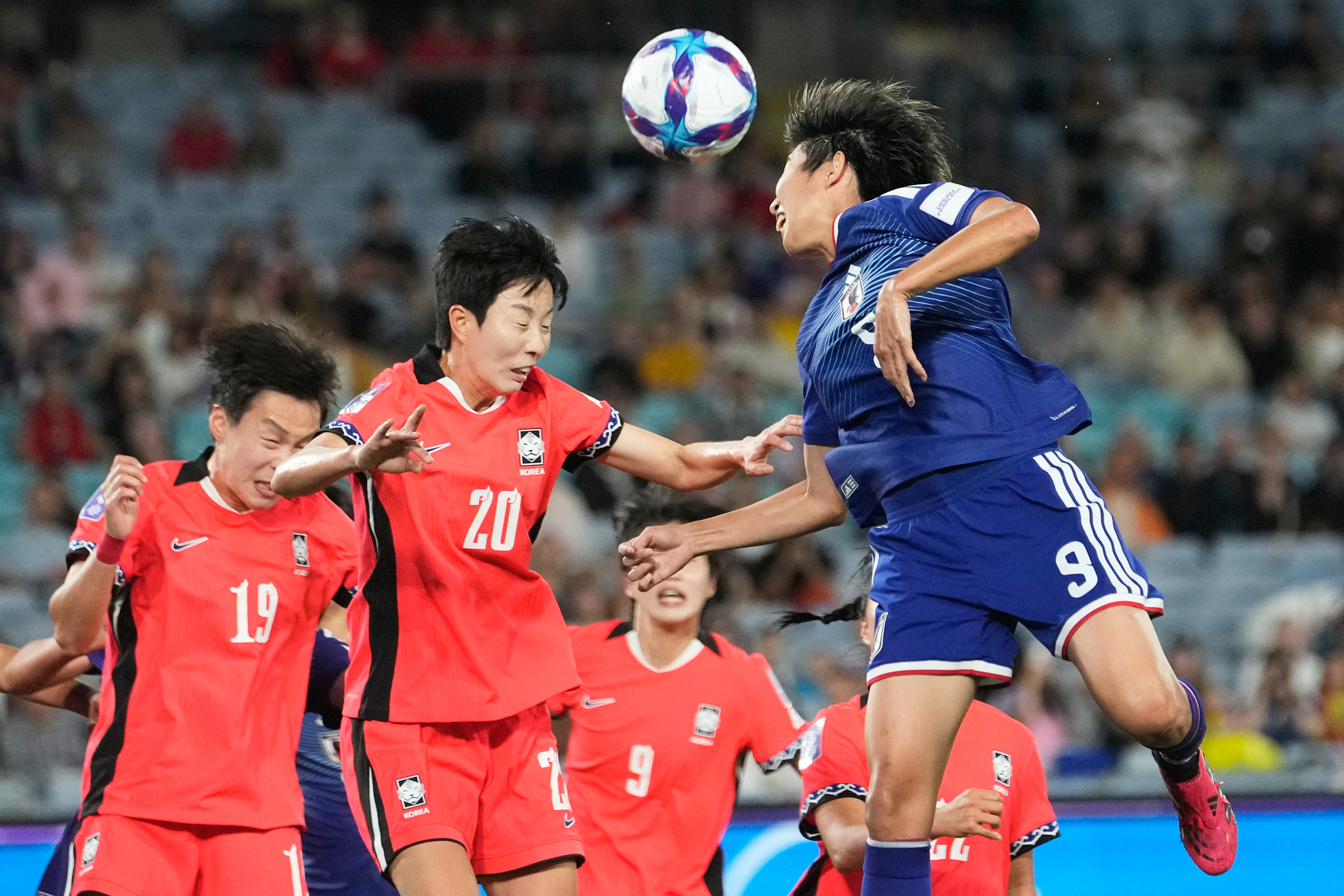 Japan's Riko Ueki, right, heads the ball during the Women's Asian Cup semifinal soccer match between Japan and South Korea