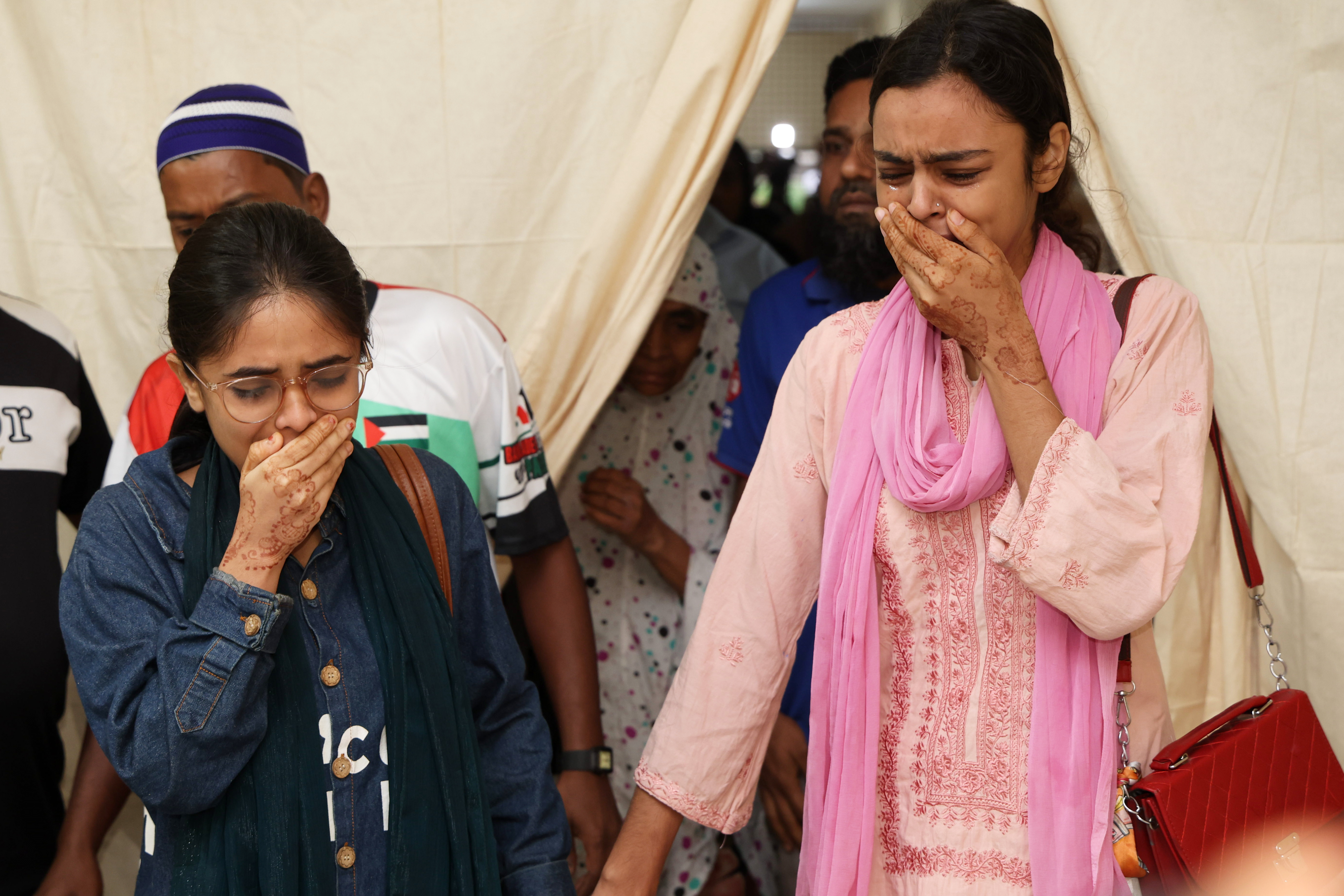 Victims' relatives break down at Rajbari hospital, a day after a passenger bus plunged into the Padma River in Bangladesh