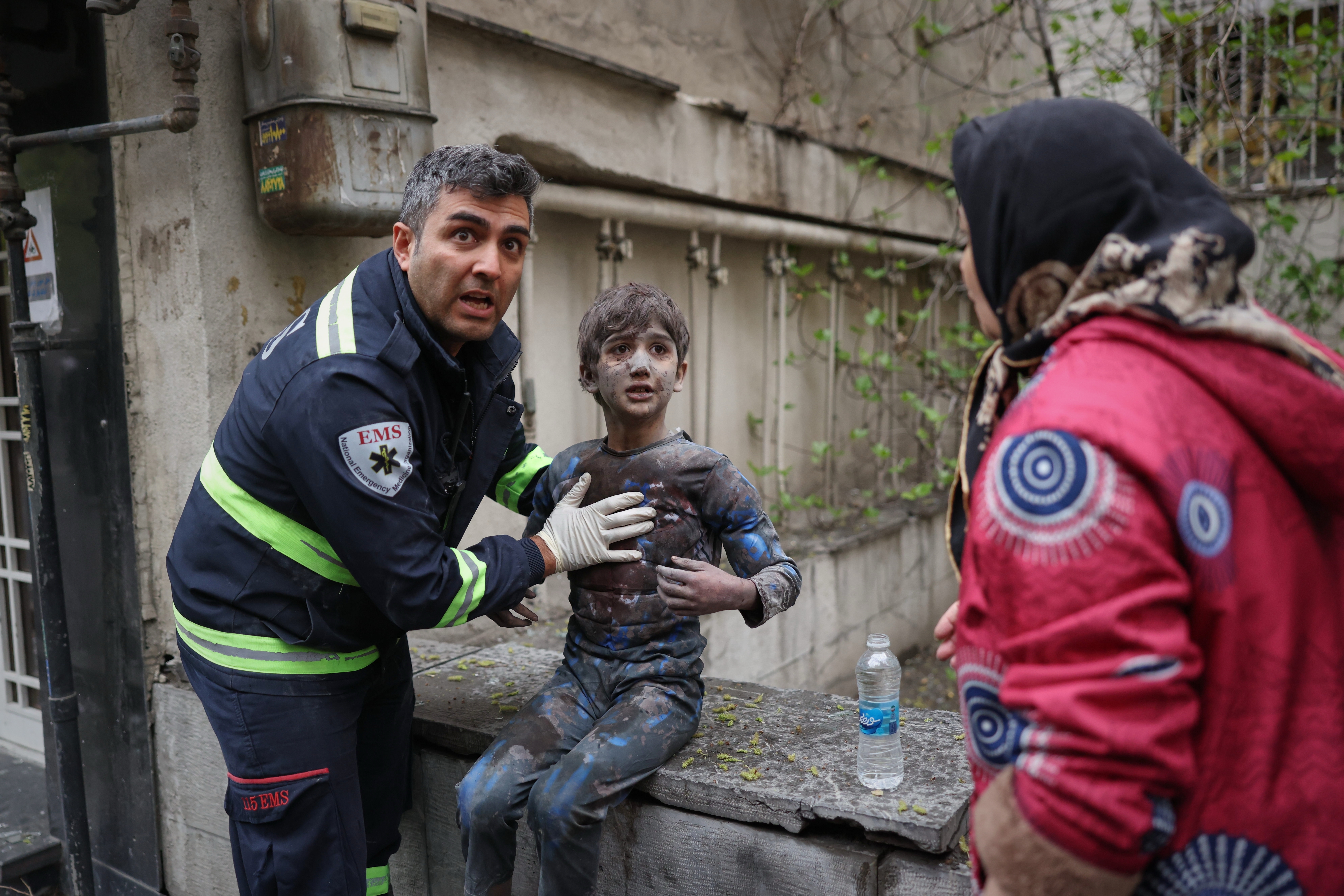 A first responder assists an injured boy following a strike that hit a residential building amid the U.S.-Israeli military campaign in Tehran, Iran, Saturday, March 28, 2026.A first responder assists an injured boy following a strike that hit a residential building amid the U.S.-Israeli military campaign in Tehran, Iran, Saturday, March 28, 2026.