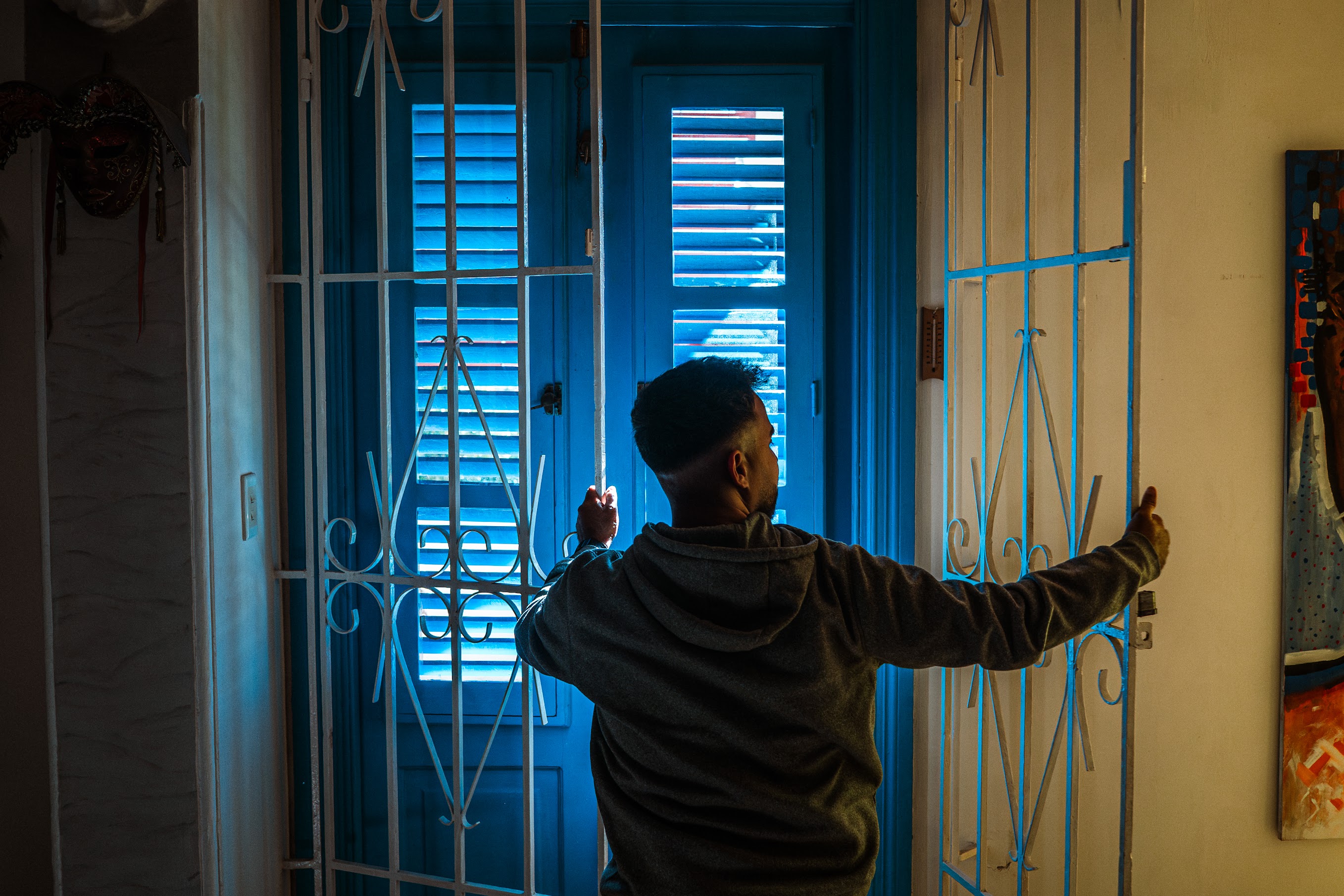 A man closes a gate to an Airbnb rental