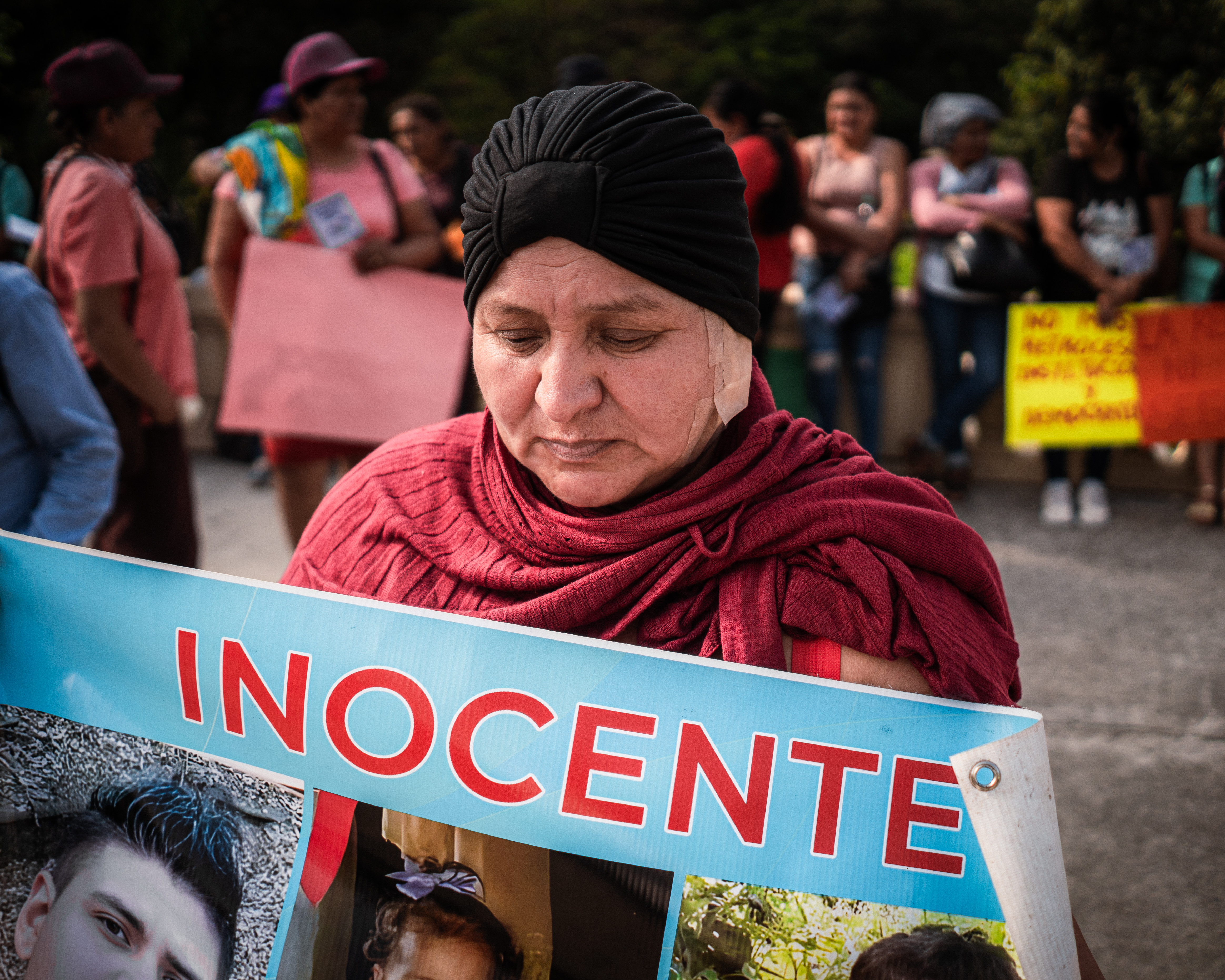Fatima Gómez, 47 years old, who cares for her two granddaughters after her son was arrested under the state of emergency in April 2022, during the March 8 protest in San Salvador [Euan Wallace/ Al Jazeera]